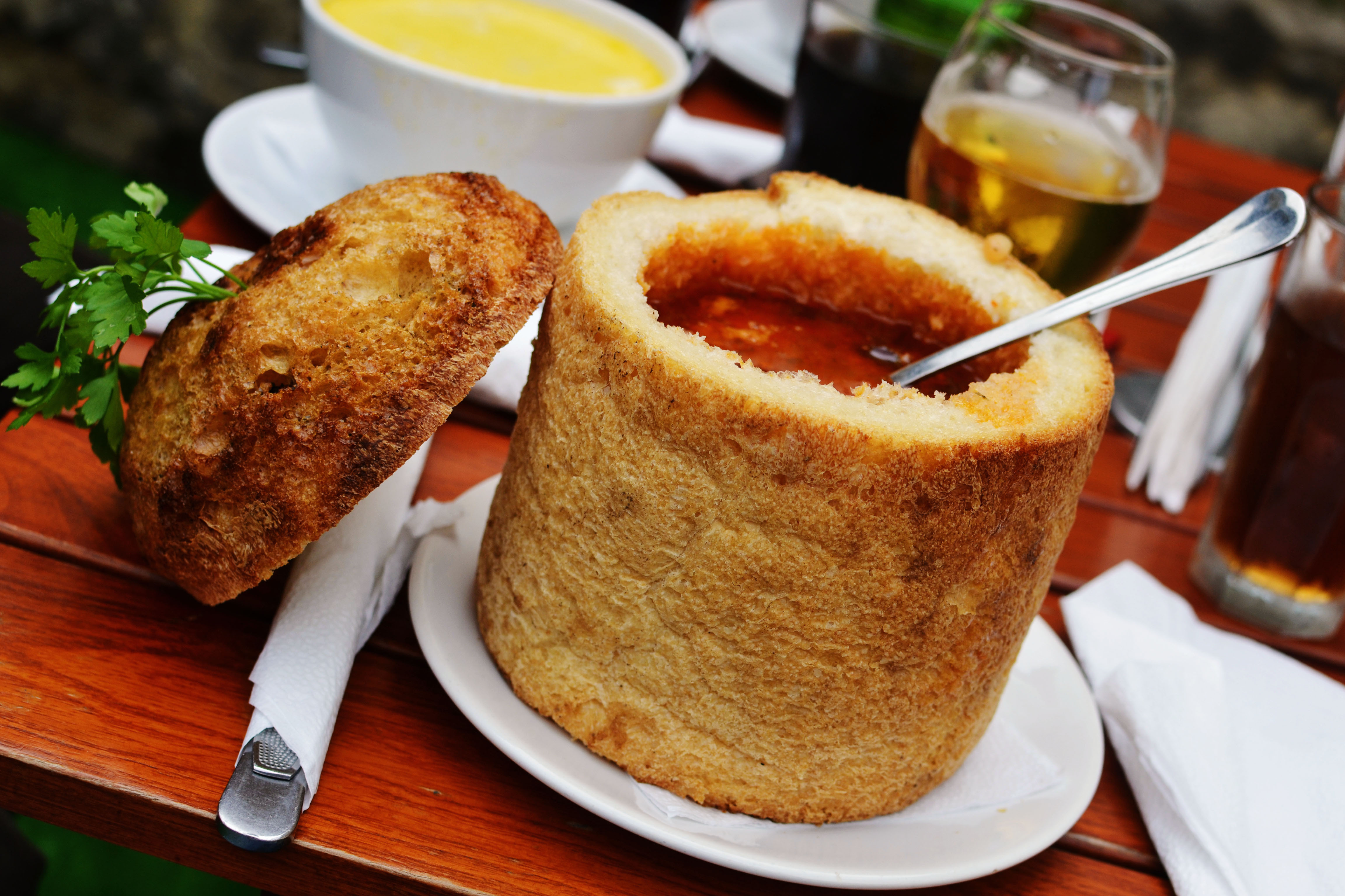 Traditional Romanian beans soup in bread, with spoon, from Transylvania region.