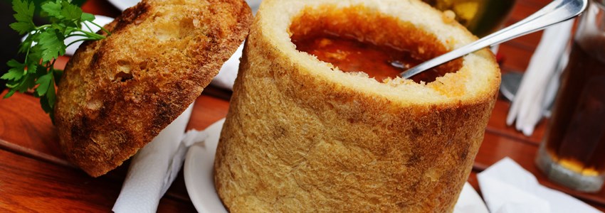 Traditional Romanian beans soup in bread, with spoon, from Transylvania region.