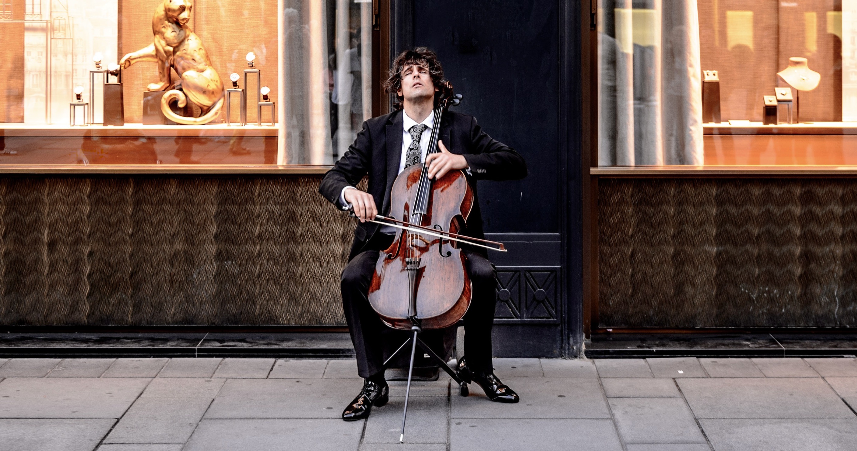 man playing cello on the street in Vienna