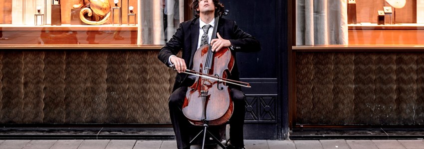 man playing cello on the street in Vienna