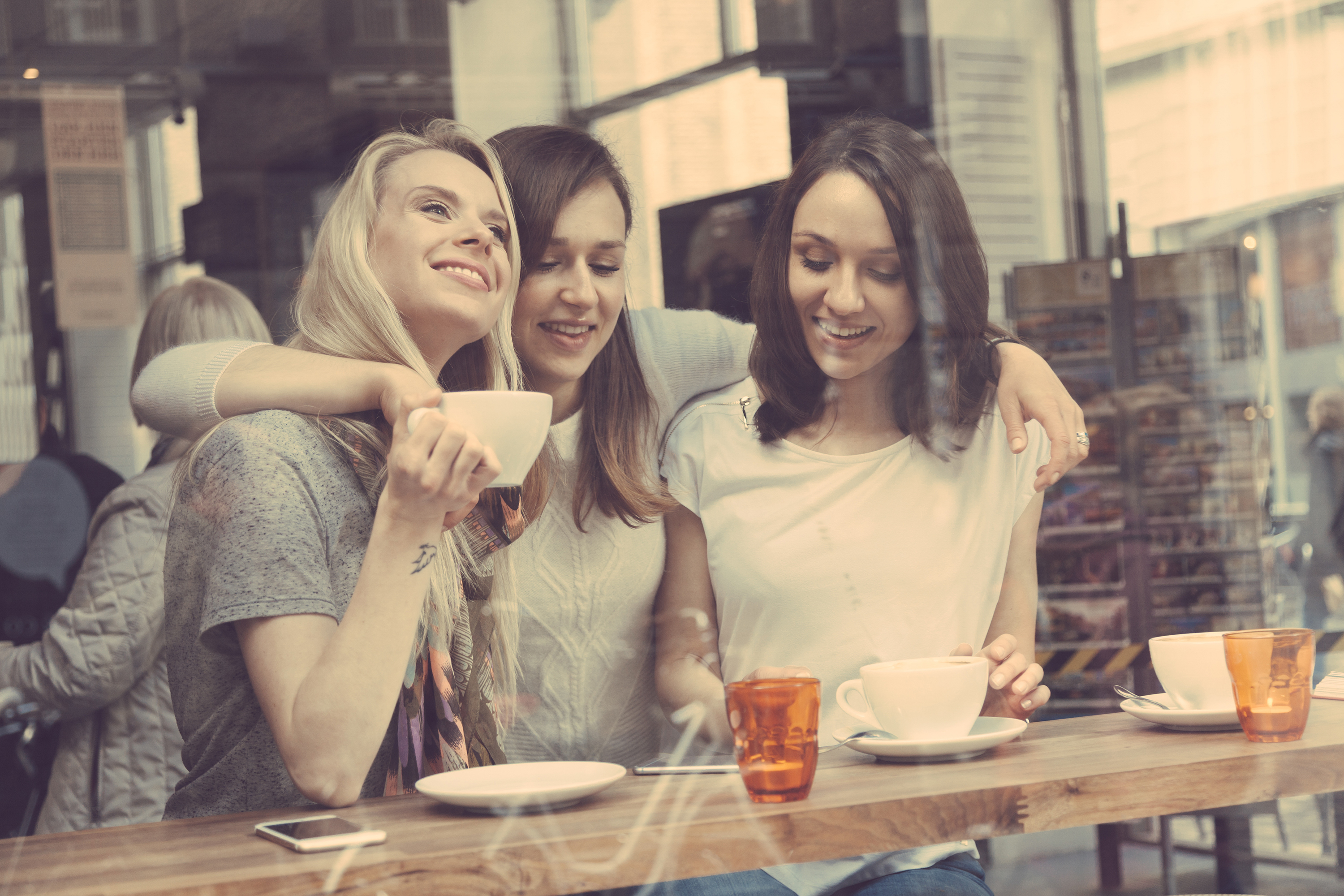 Happy women enjoying a coffee.