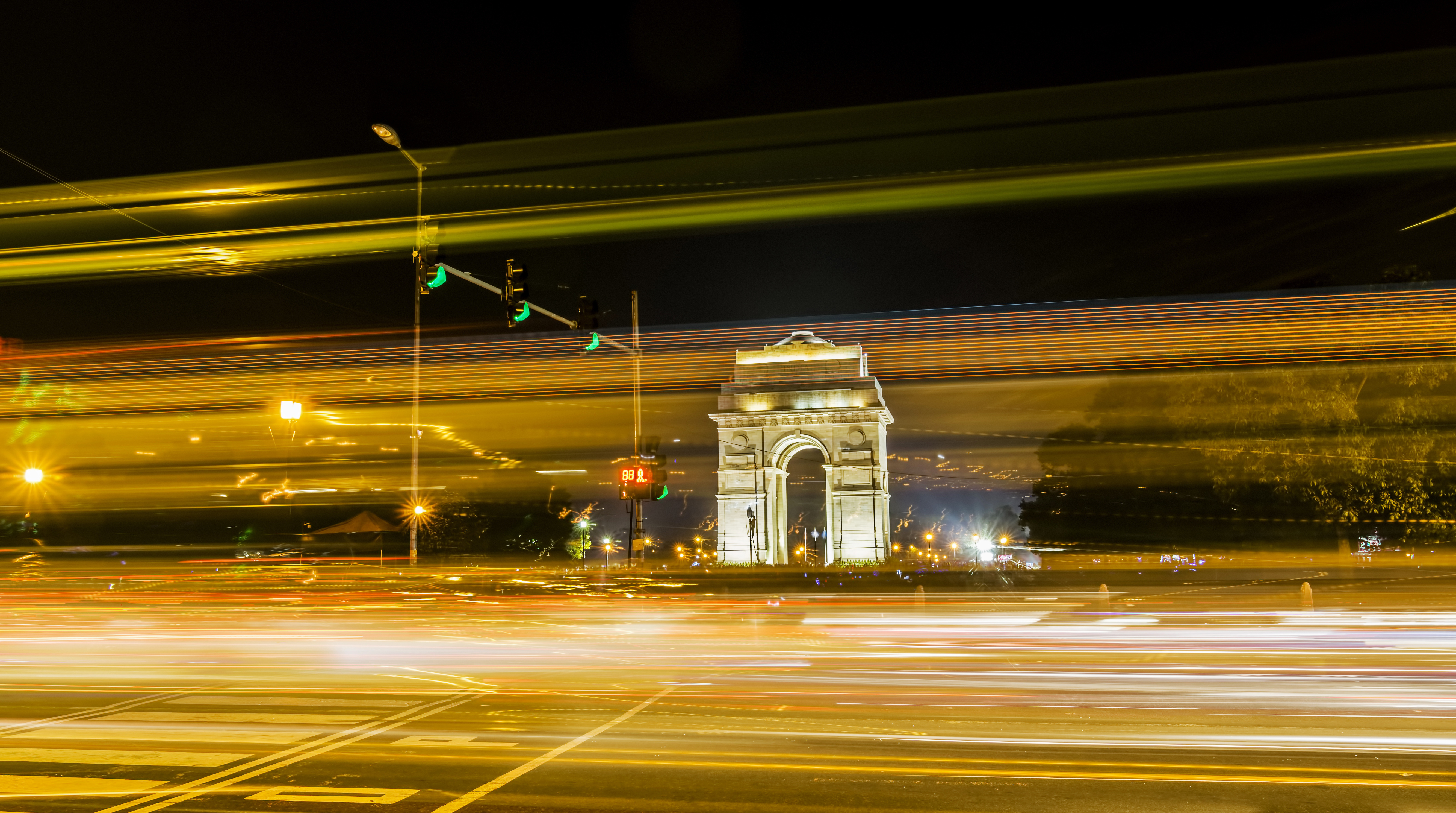 A wide angle long exposure shot of India Gate (formerly known as the All India War Memorial) with light trails of moving vehicles at Rajpath, New Delhi, India.