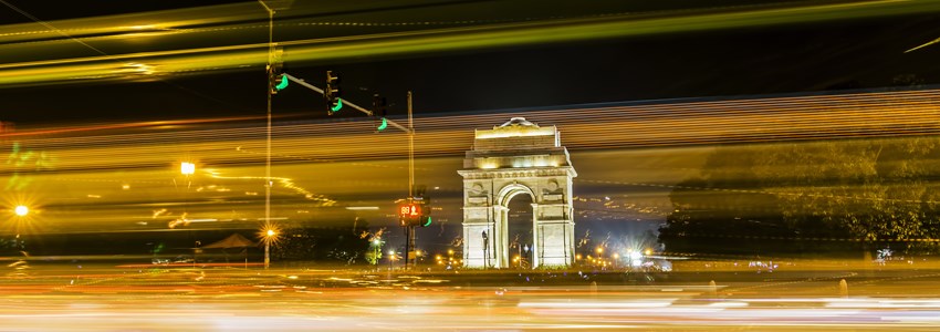 A wide angle long exposure shot of India Gate (formerly known as the All India War Memorial) with light trails of moving vehicles at Rajpath, New Delhi, India.