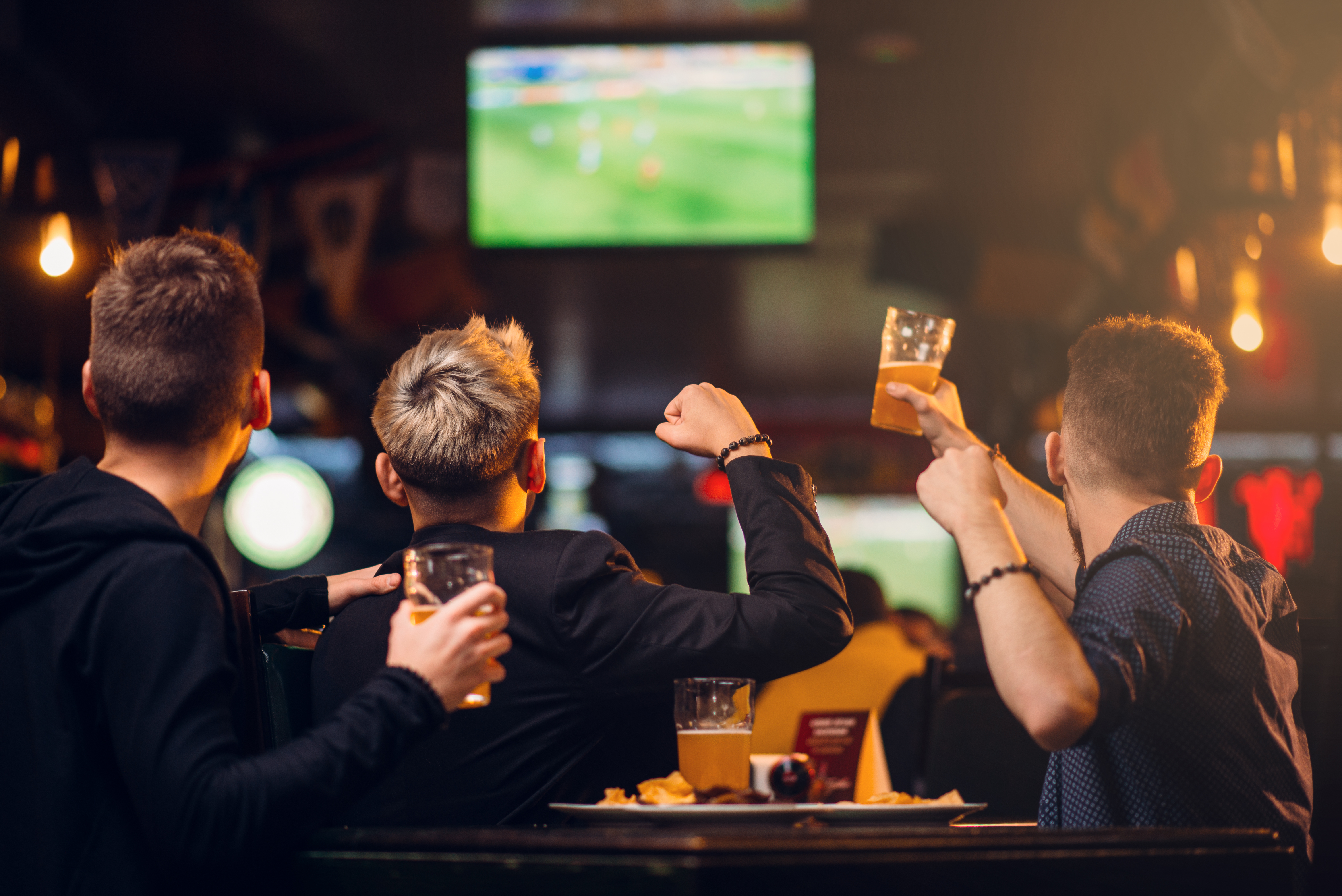 Men watching a match in a pub