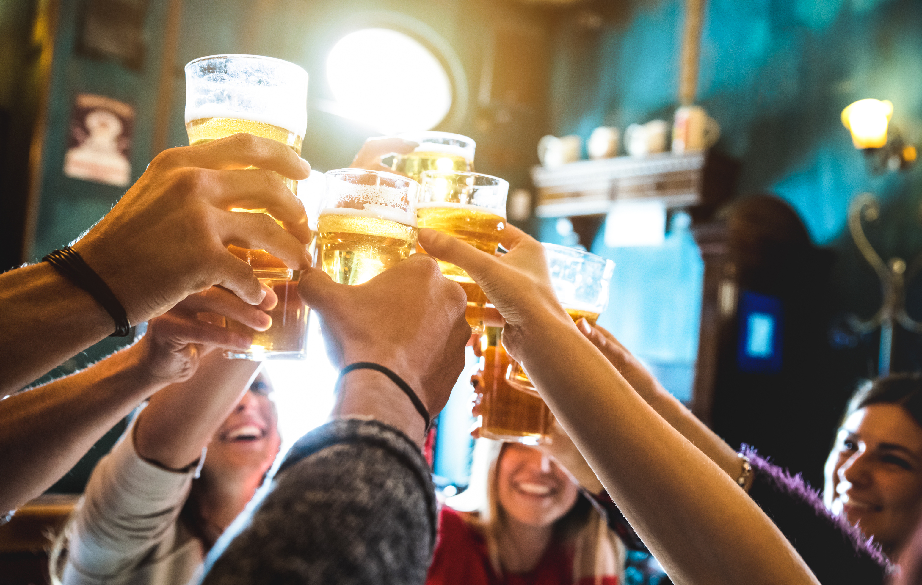 Group of friends drinking and toasting beer