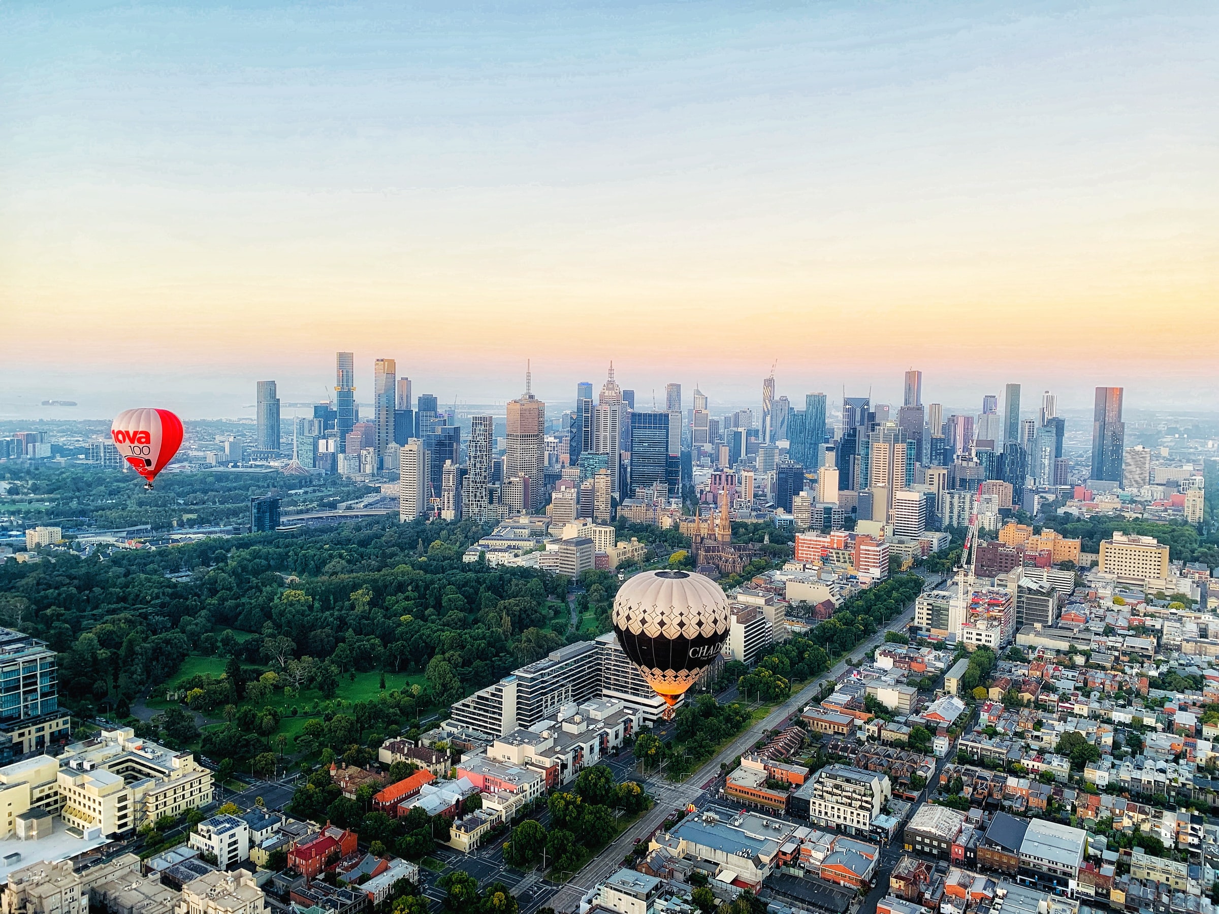 Hot air balloons flying over Melbourne skyline