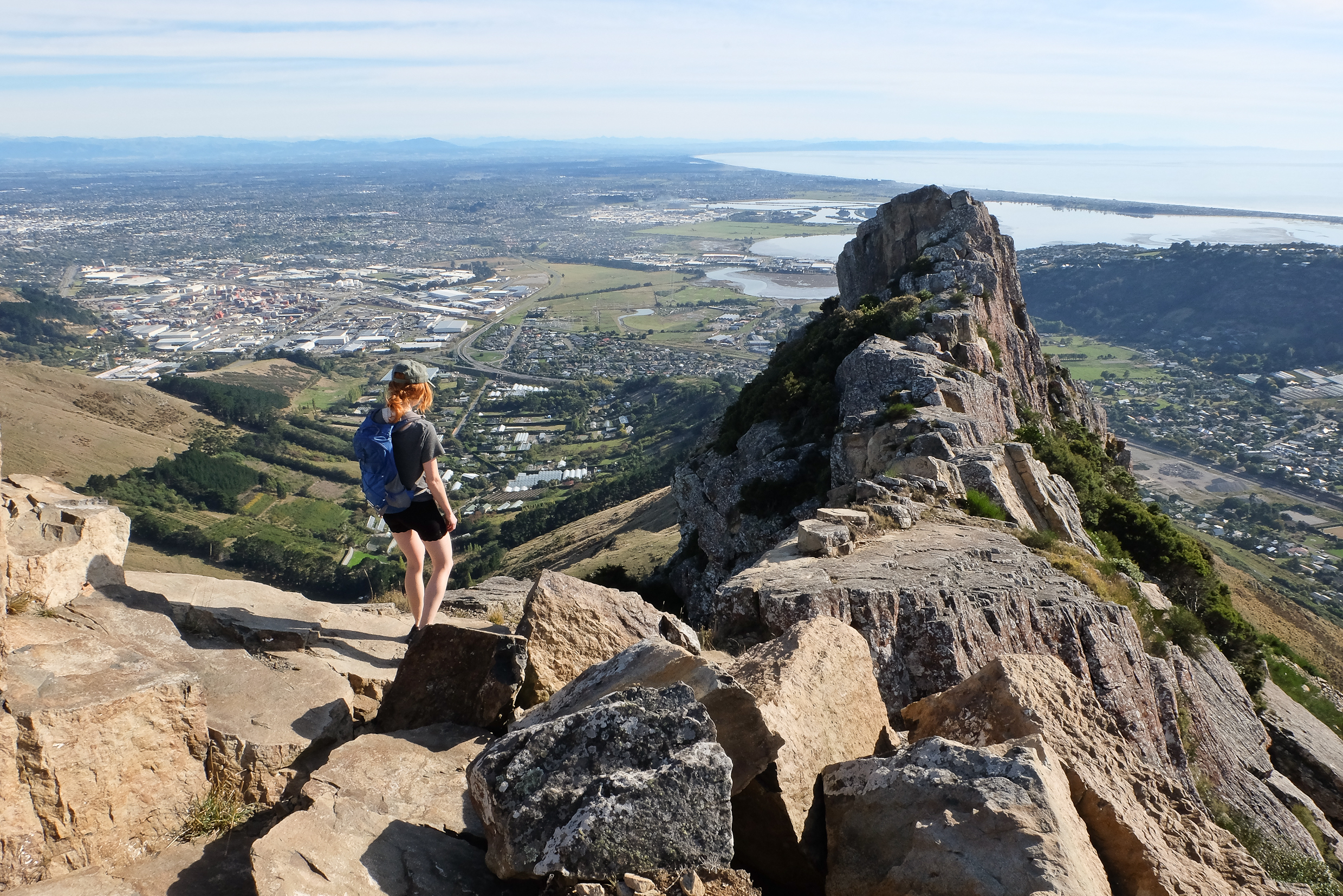 Woman Hiker Ascending Castle Rock. Port Hills, Christchurch, New Zealand.