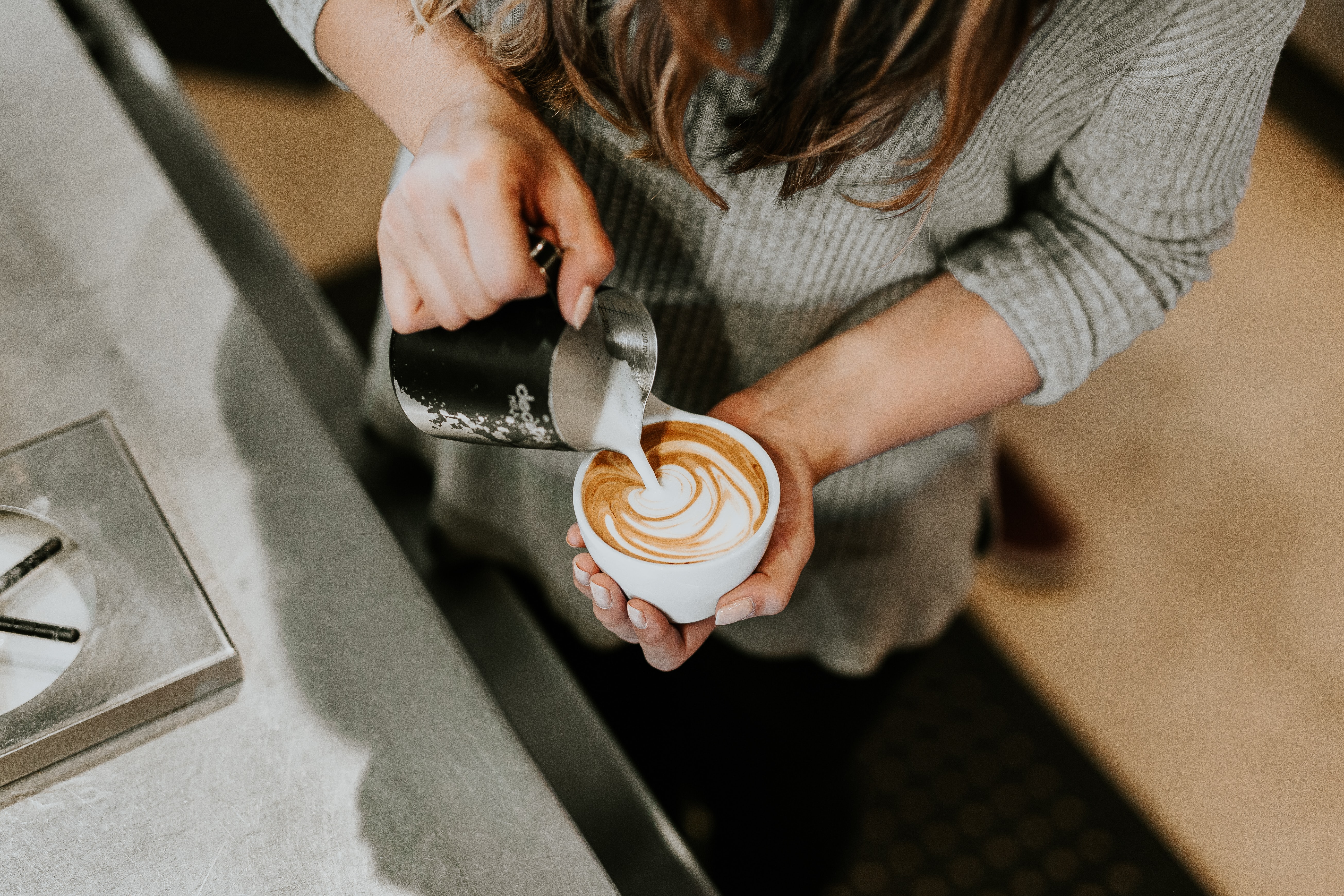 barista pouring a cappuccino