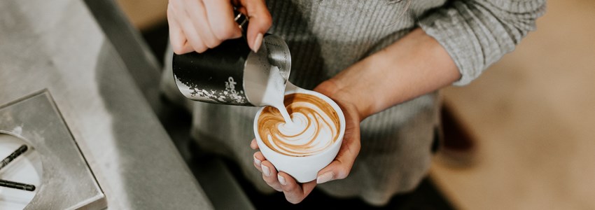 barista pouring a cappuccino