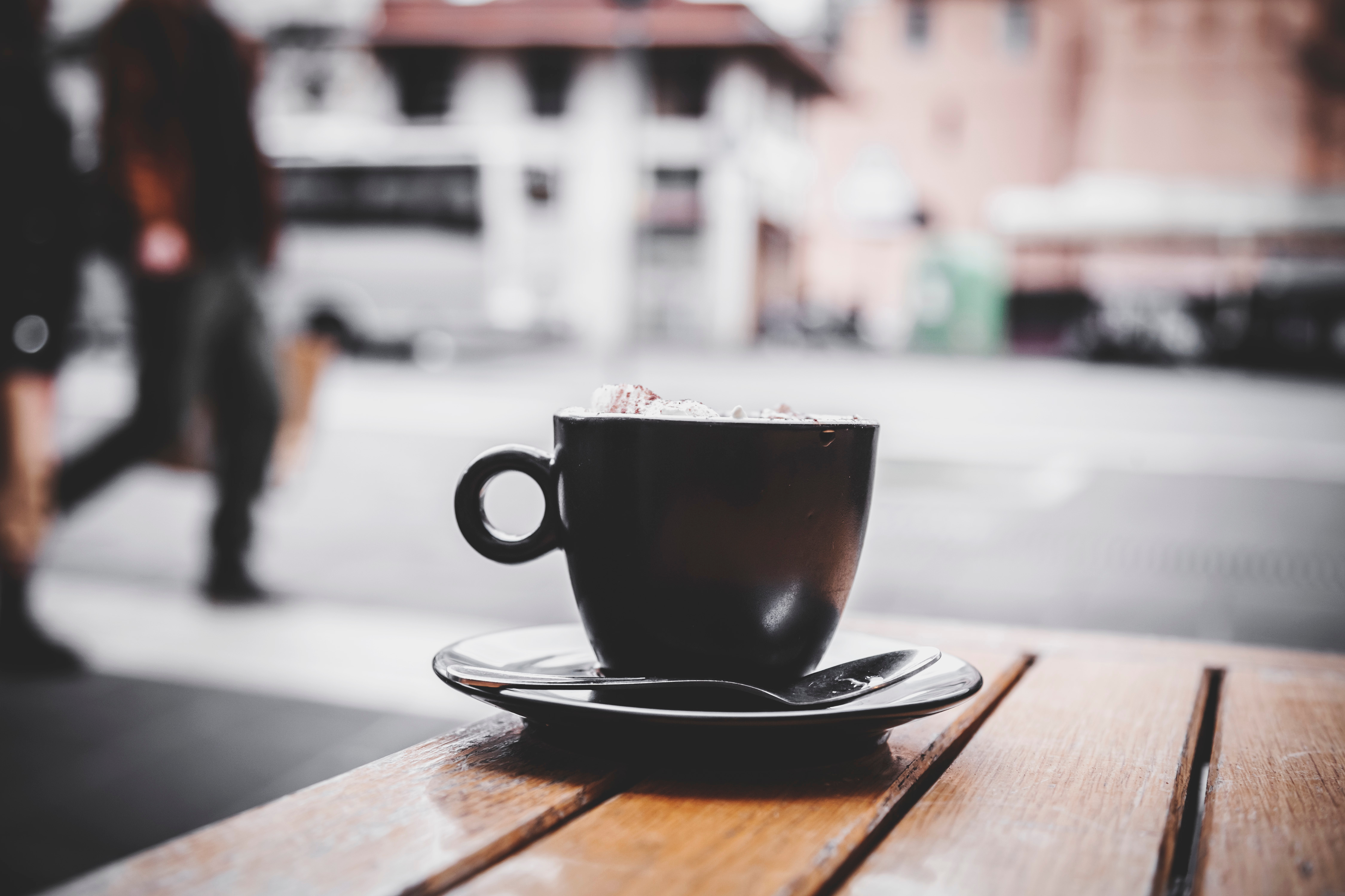 Italian espresson con panna in a black cup. Espresso with whipped cream