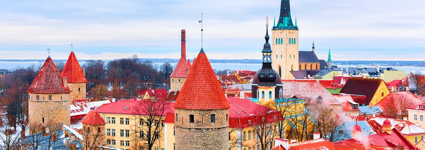 Cityscape with St Olaf Church and defensive towers at the Old town of Tallinn, Estonia in winter.