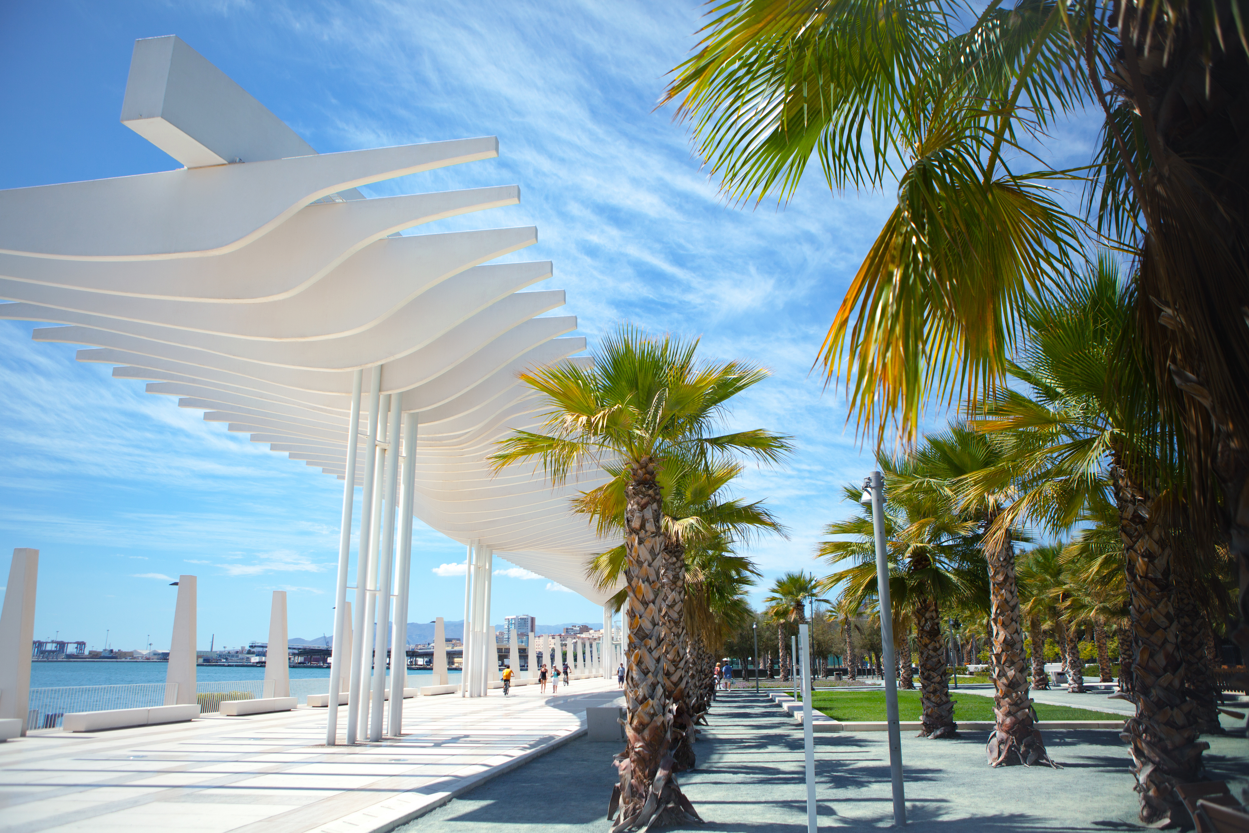 White pergola and palm trees along Malaga port promenade, in the south of Spain