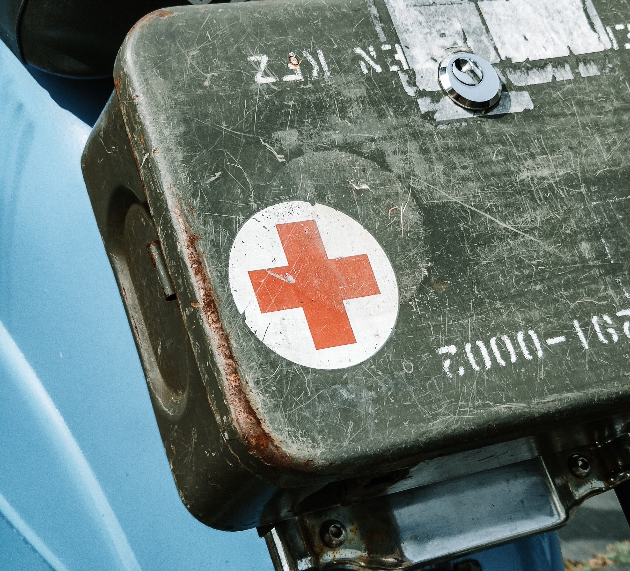 red medical cross on a portable first aid kit