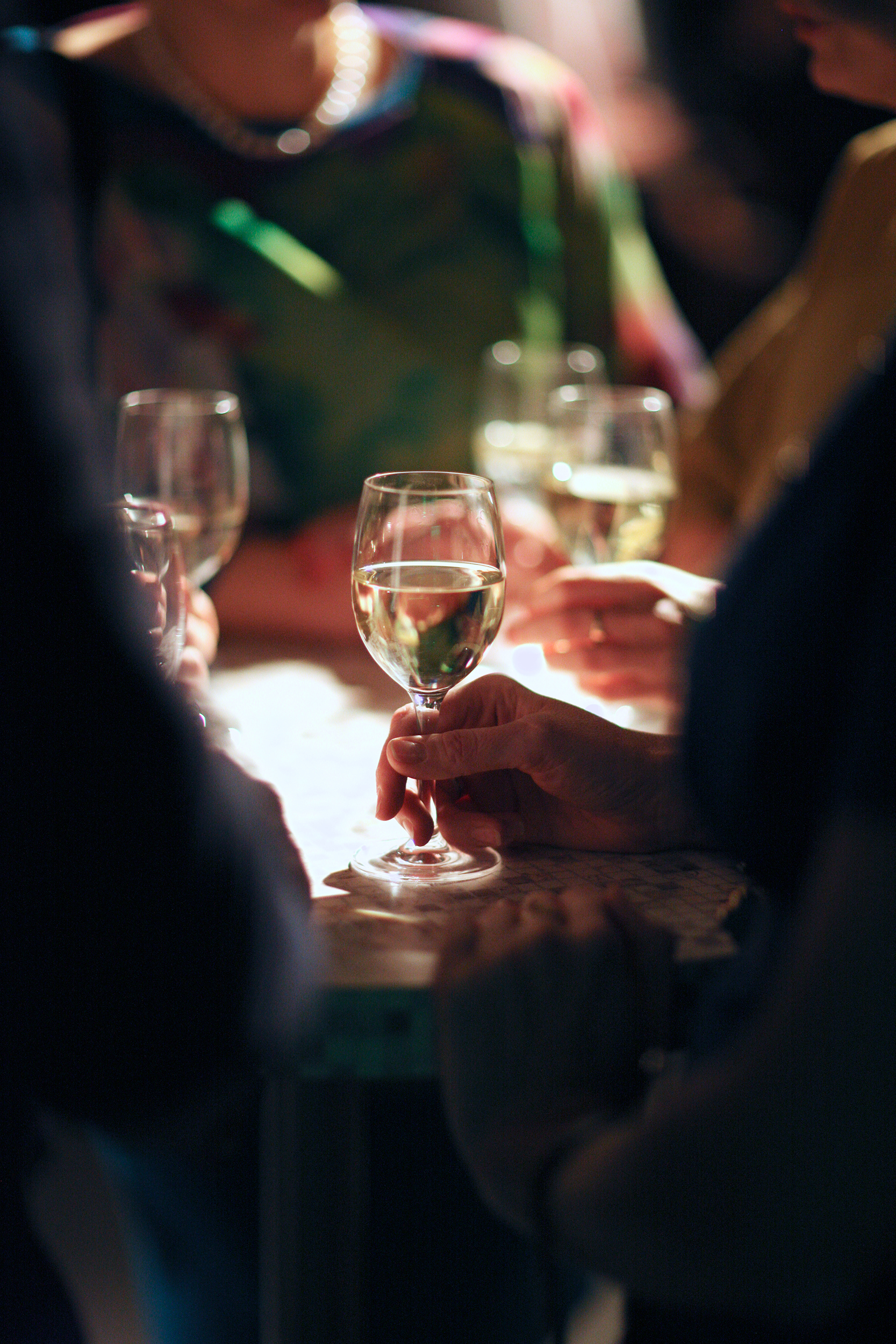 Hands holding wine glasses