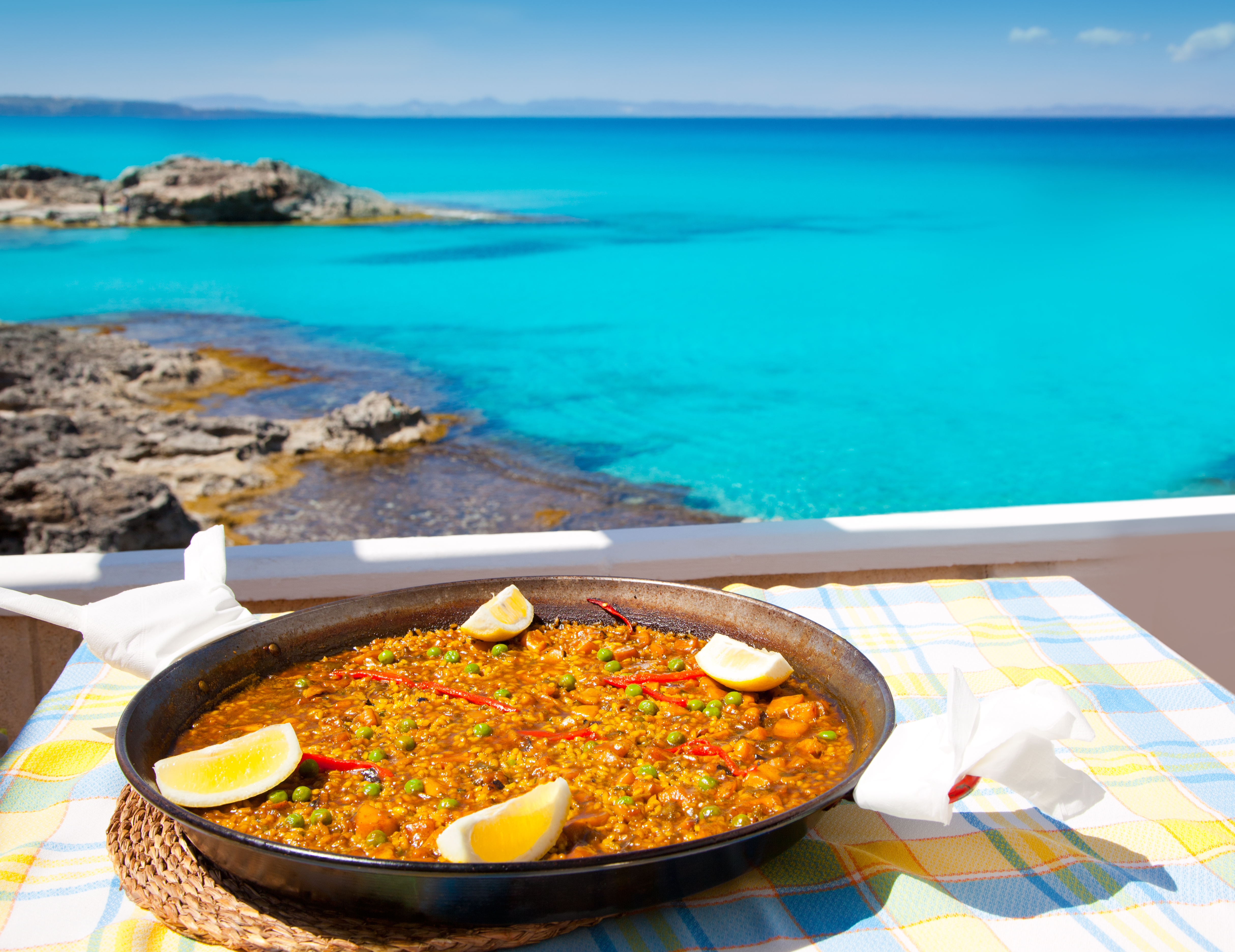 Paella mediterranean rice food by the Balearic Formentera island beach [ photo-illustration]