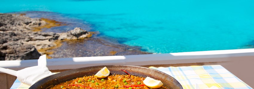 Paella mediterranean rice food by the Balearic Formentera island beach [ photo-illustration]