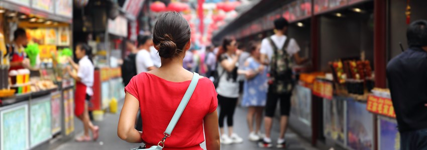 Asian girl on Wangfujing food street during Asia summer vacation