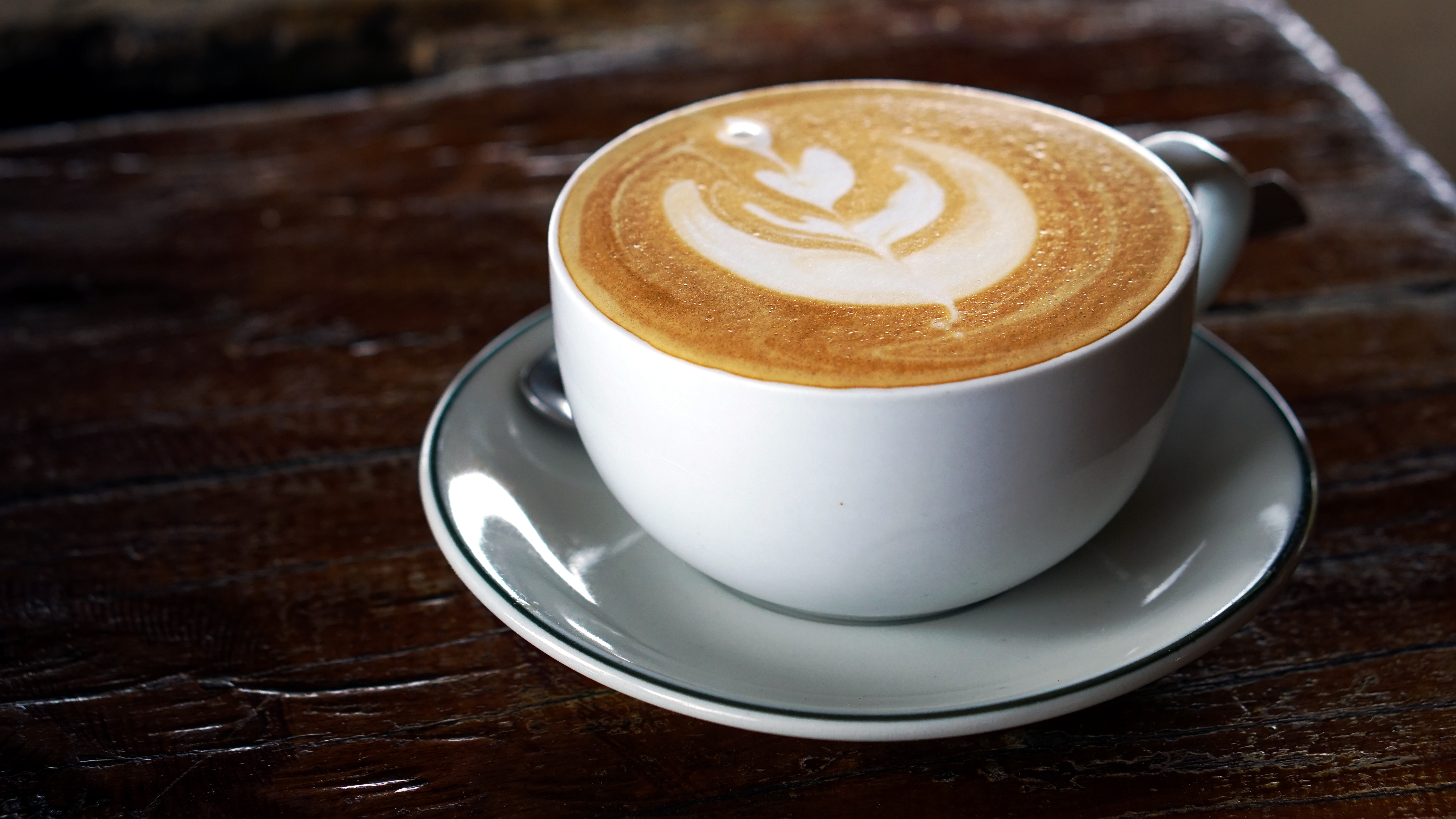 The cup of latte or cappuccino coffee with milk