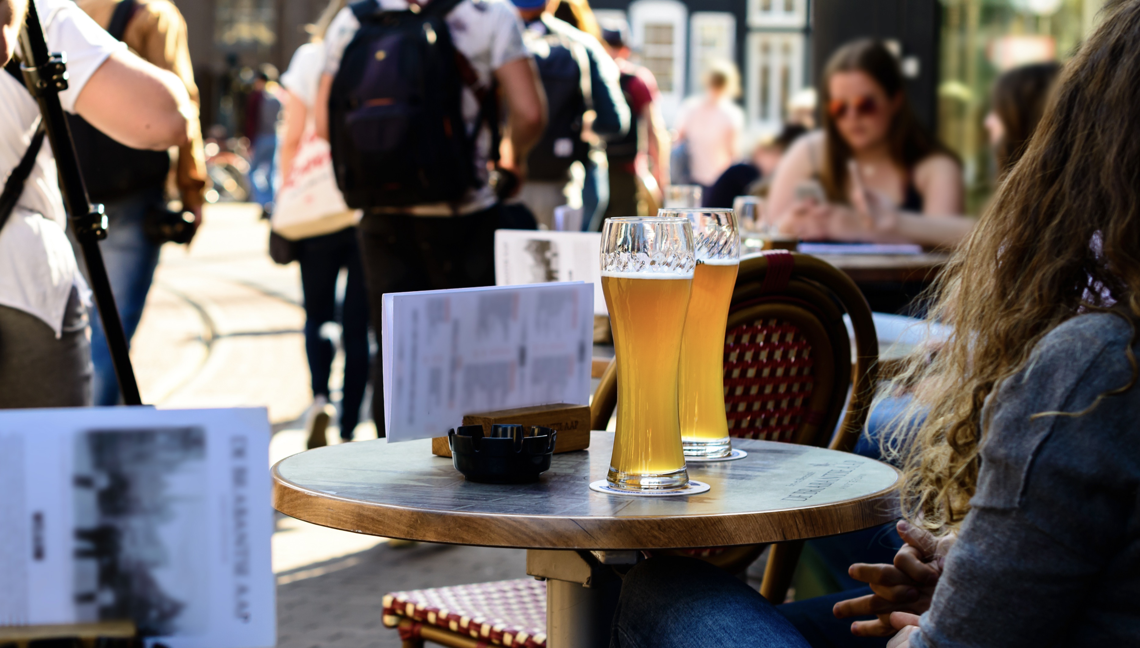 girls drinking cold light beer in a street cafe in Amsterdam