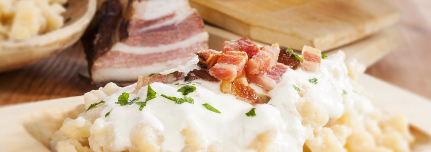 Bryndzove halusky. Potato dumplings with bryndza sheep cheese and bacon. Bryndzove halusky, traditional national slovak food.