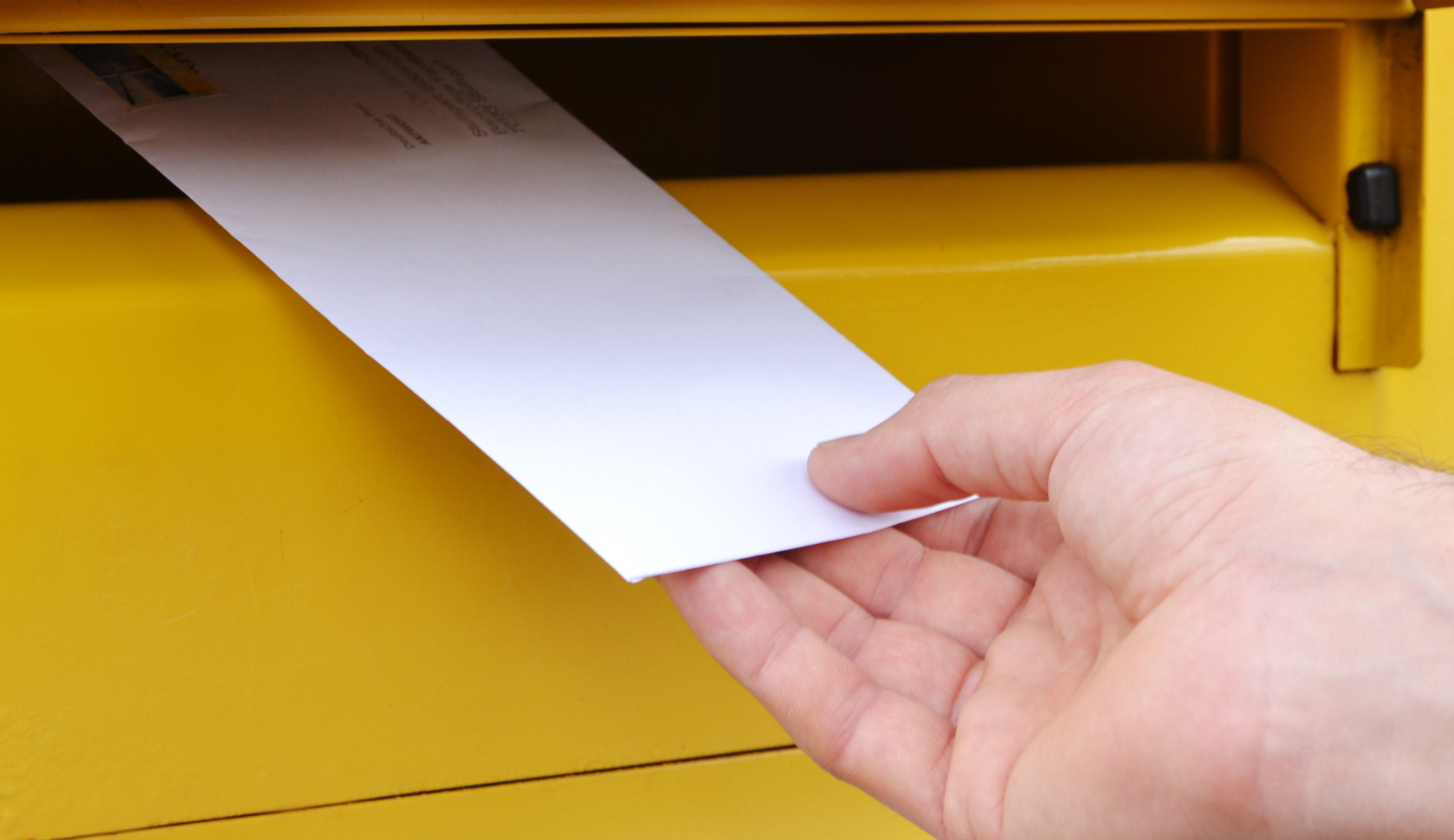 Paper envelope with letter sending in yellow mailbox