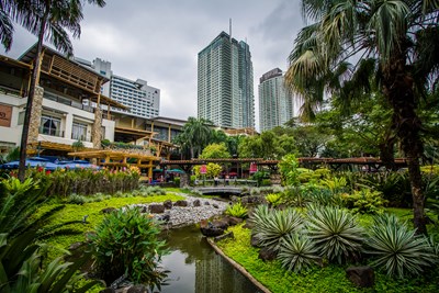 Gardens and skyscrapers at Greenbelt Park, in Ayala, Makati, Metro Manila, The Philippines. - Jon Bilous/Shutterstock.com