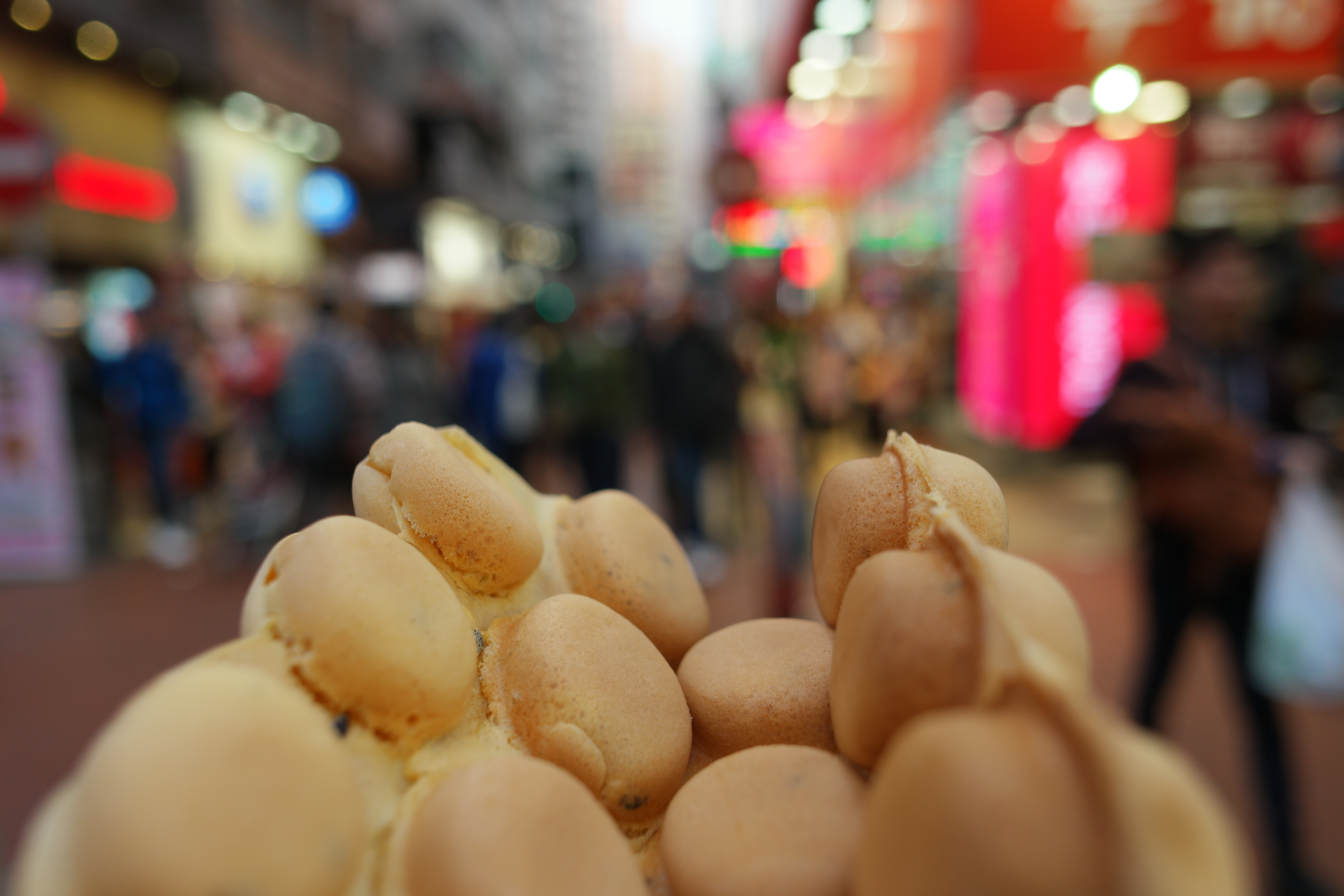 Famous HongKong waffle at the bussy Streets with crowd of people of MongKok bokeh effect blurry background, Hong Kong February 2017