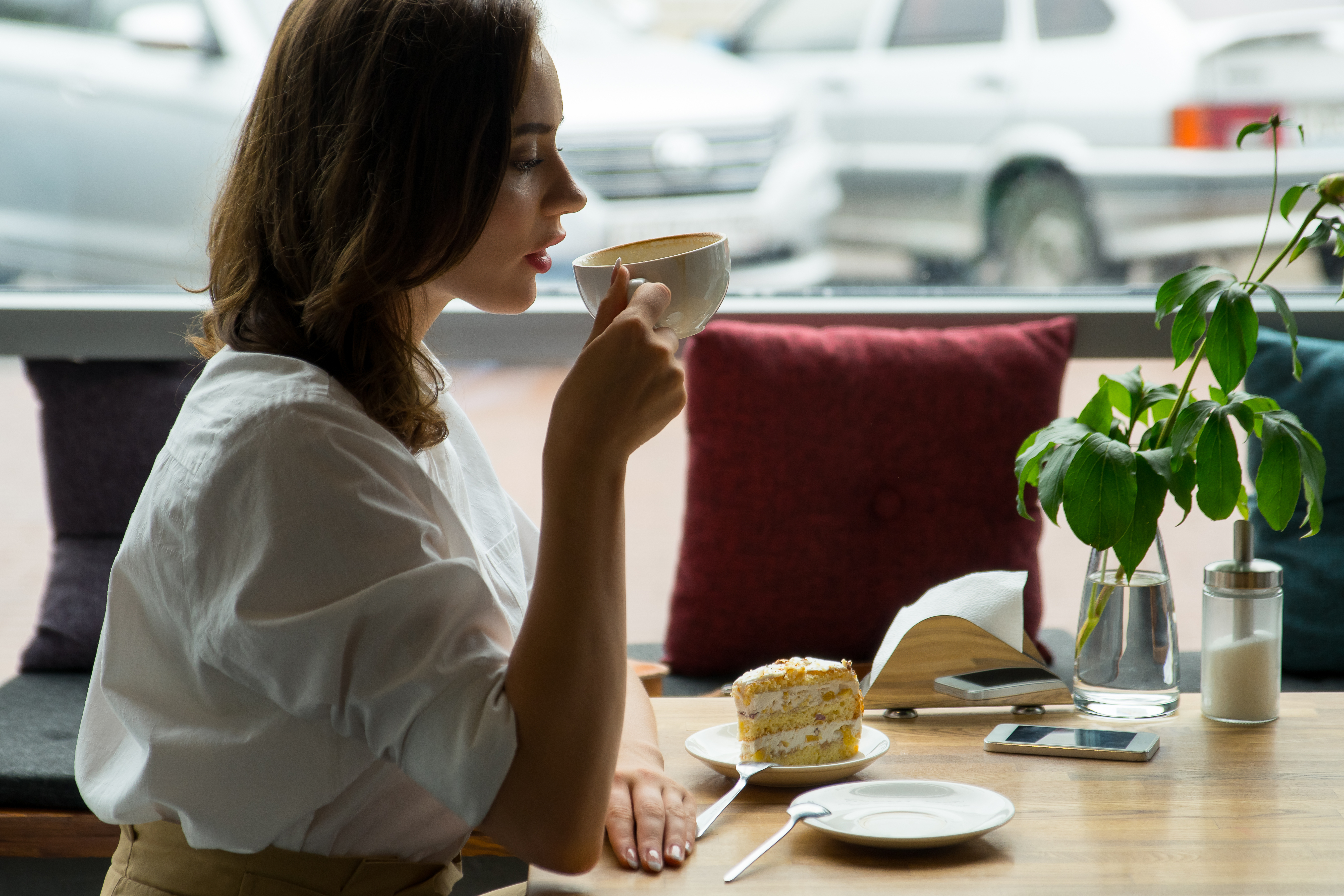 Girl drinking a cup of coffee in a cafe - San Francisco, California