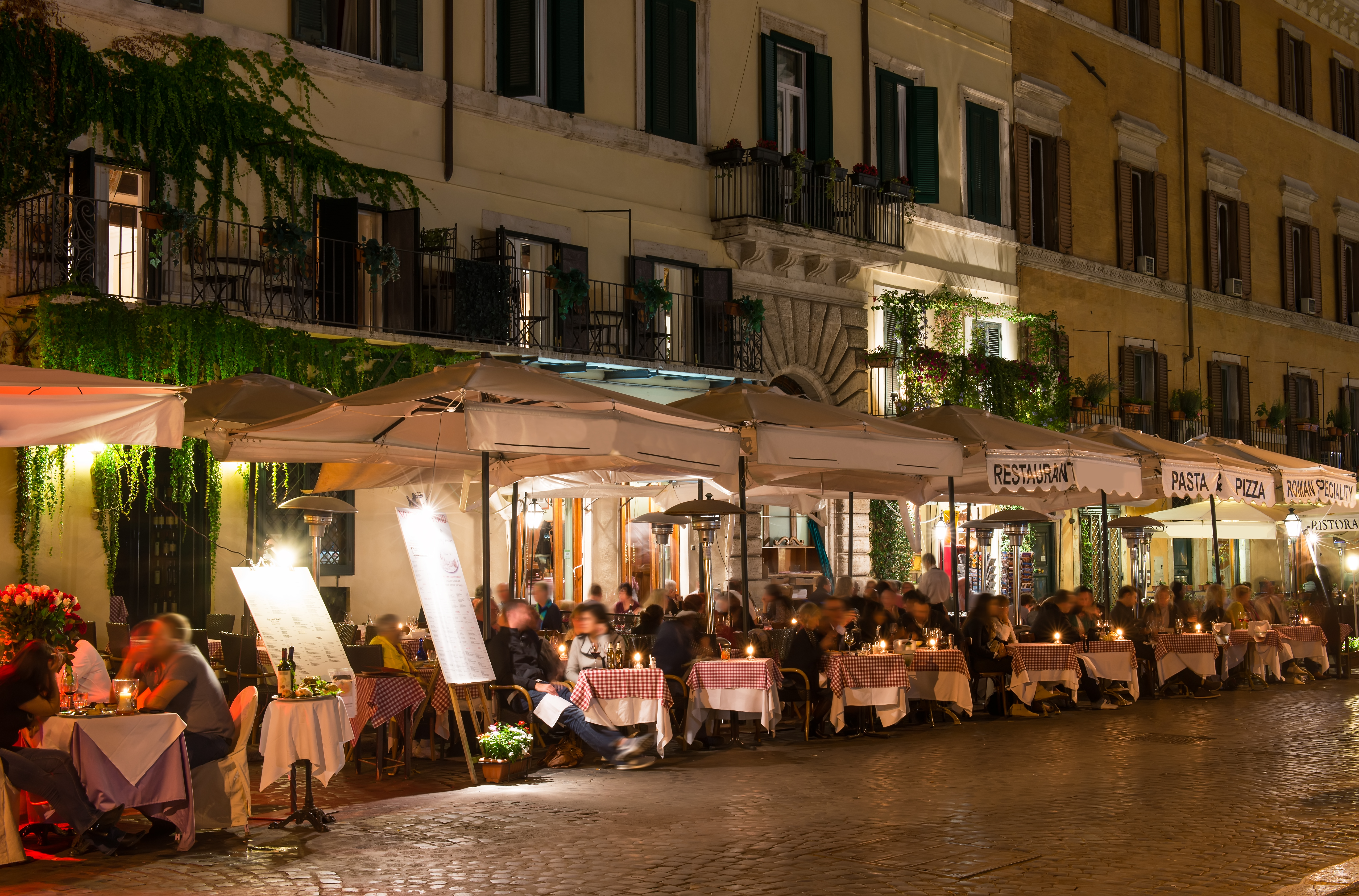 Night view of restaurants on Piazza Navona in Rome, Italy