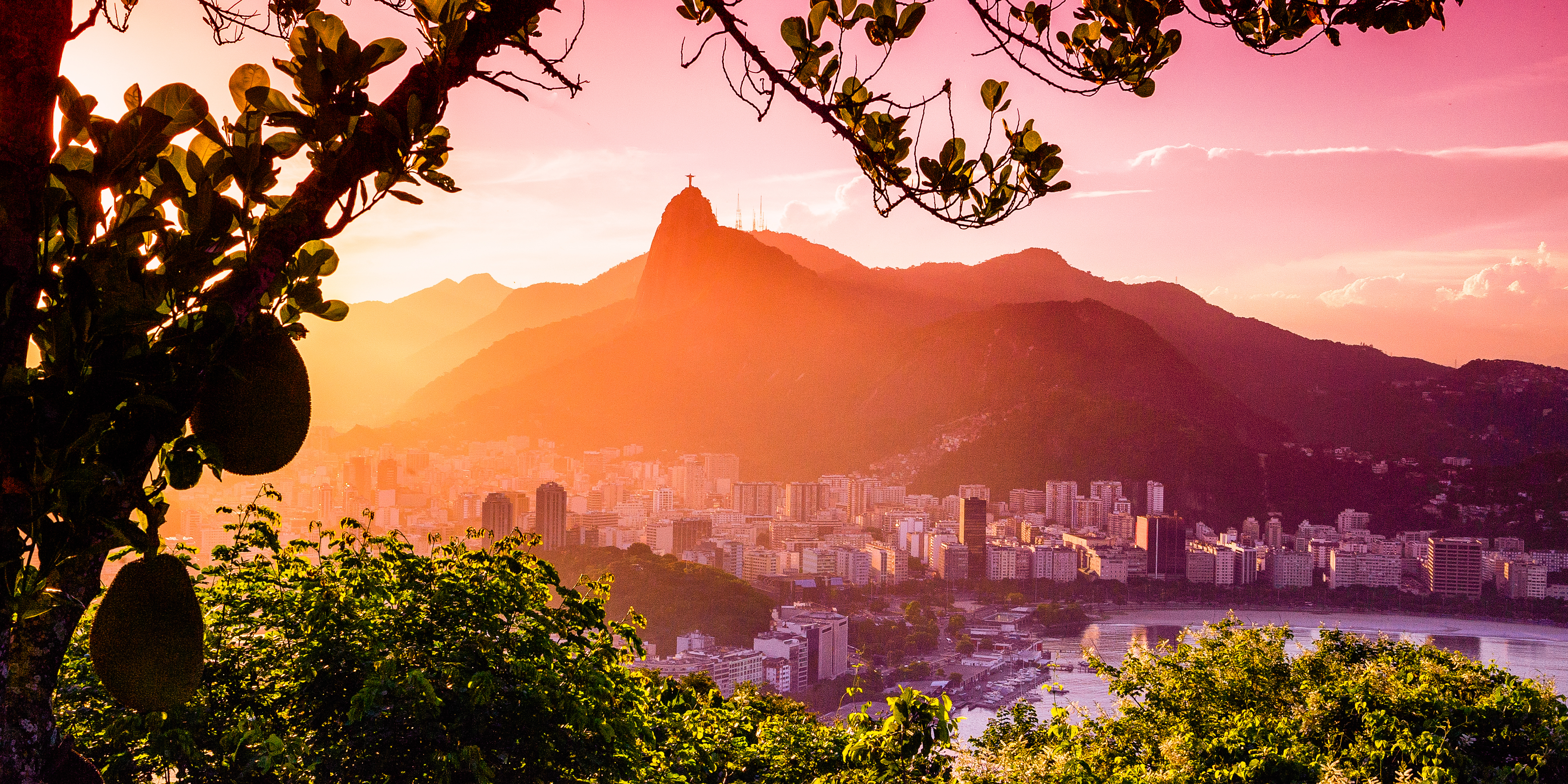 Buildings at the waterfront with Christ The Redeemer statue in the background, Corcovado, Rio de Janeiro, Brazil