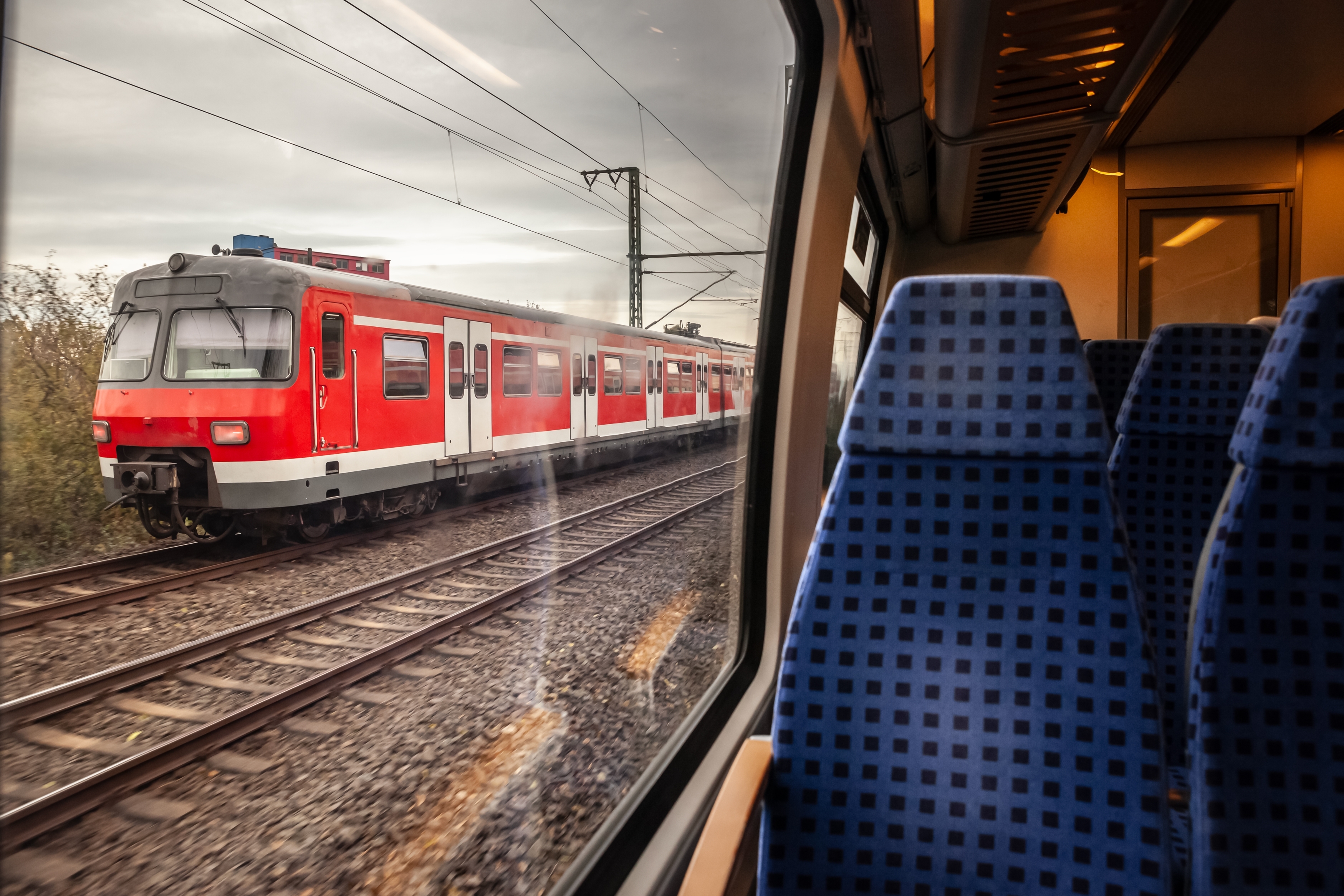 Selective blur on a German S-Bahn suburban train near Cologne seen from another train, part of Germany's public transportation system capturing the motion  connectivity of regional rail services.