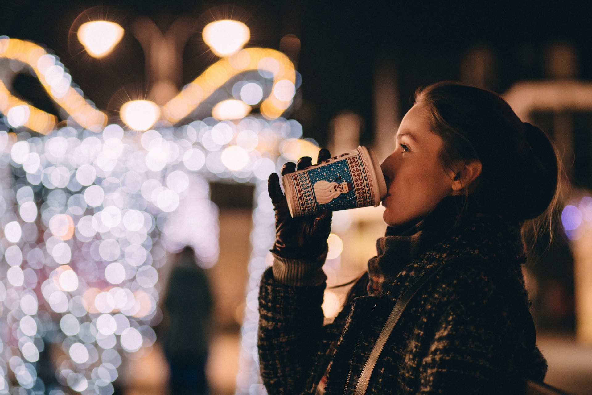 girl drinking hot coffee drink in winter street
