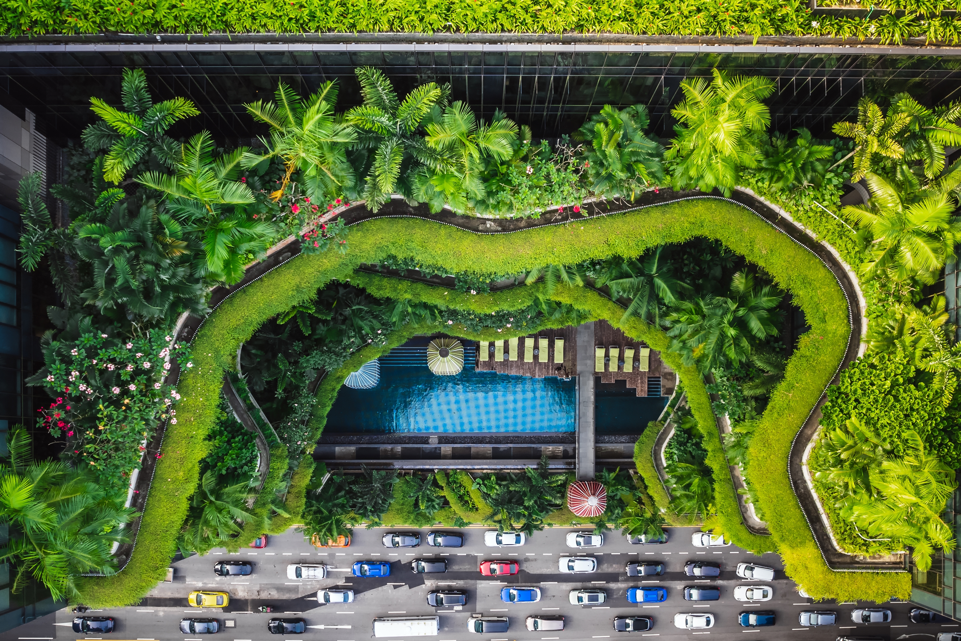 Aerial view of the famous hotel in Singapore. This building has a jungle like green facade.
