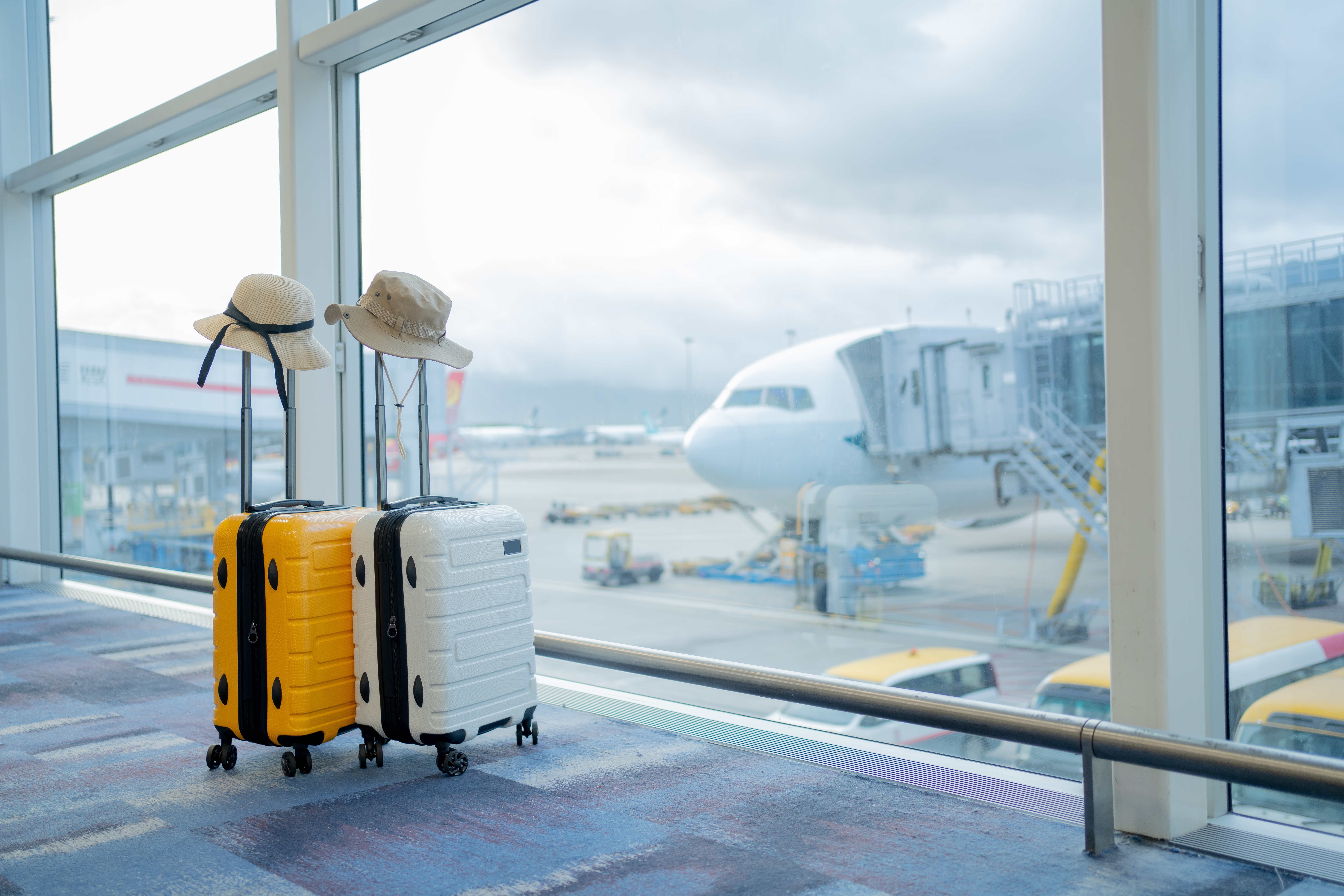 Two suitcases in an empty airport hall, traveler cases in the departure airport terminal waiting for the area, vacation concept, blank space for text message or design