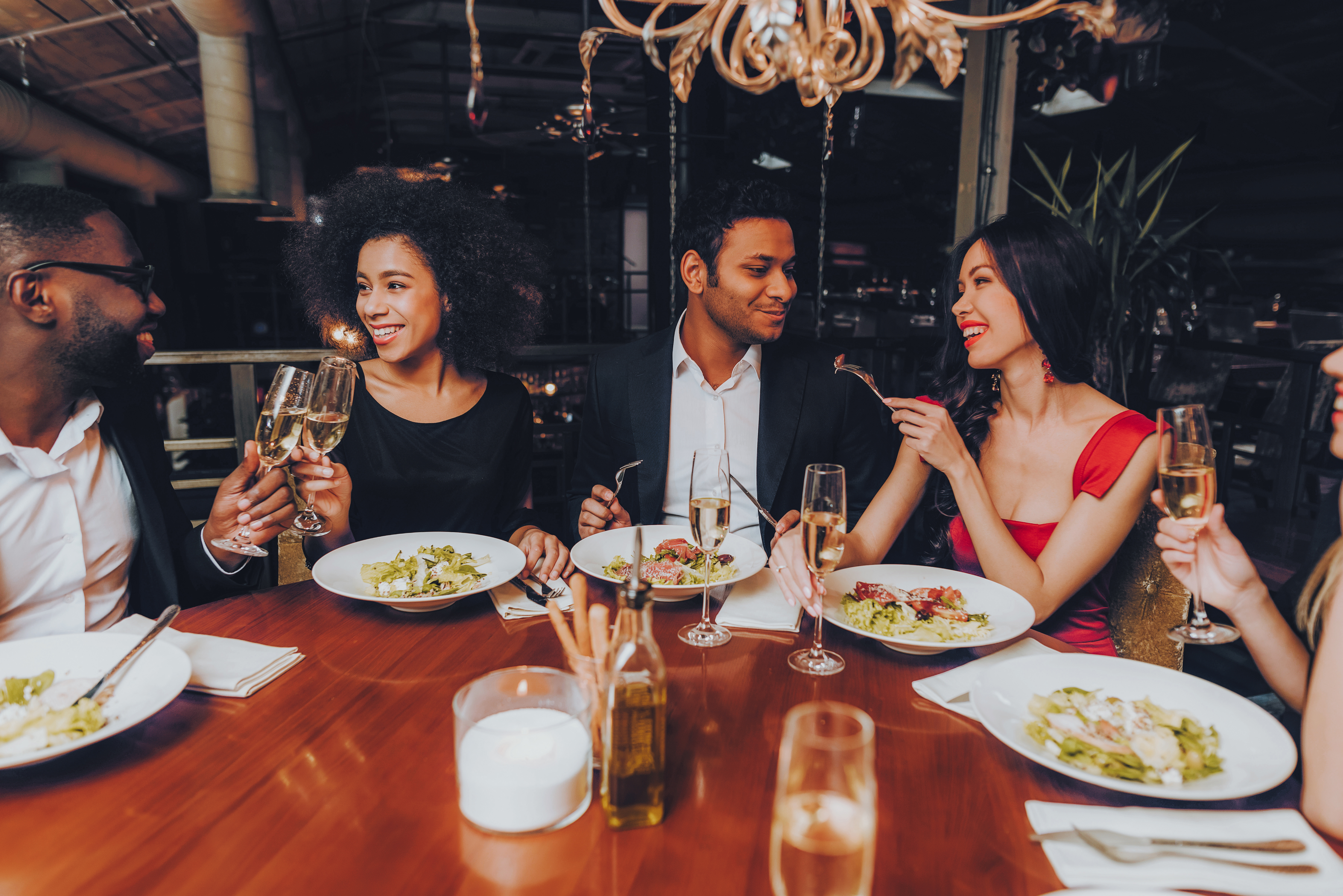 Friends Chilling Out Enjoying Meal in Restaurant.