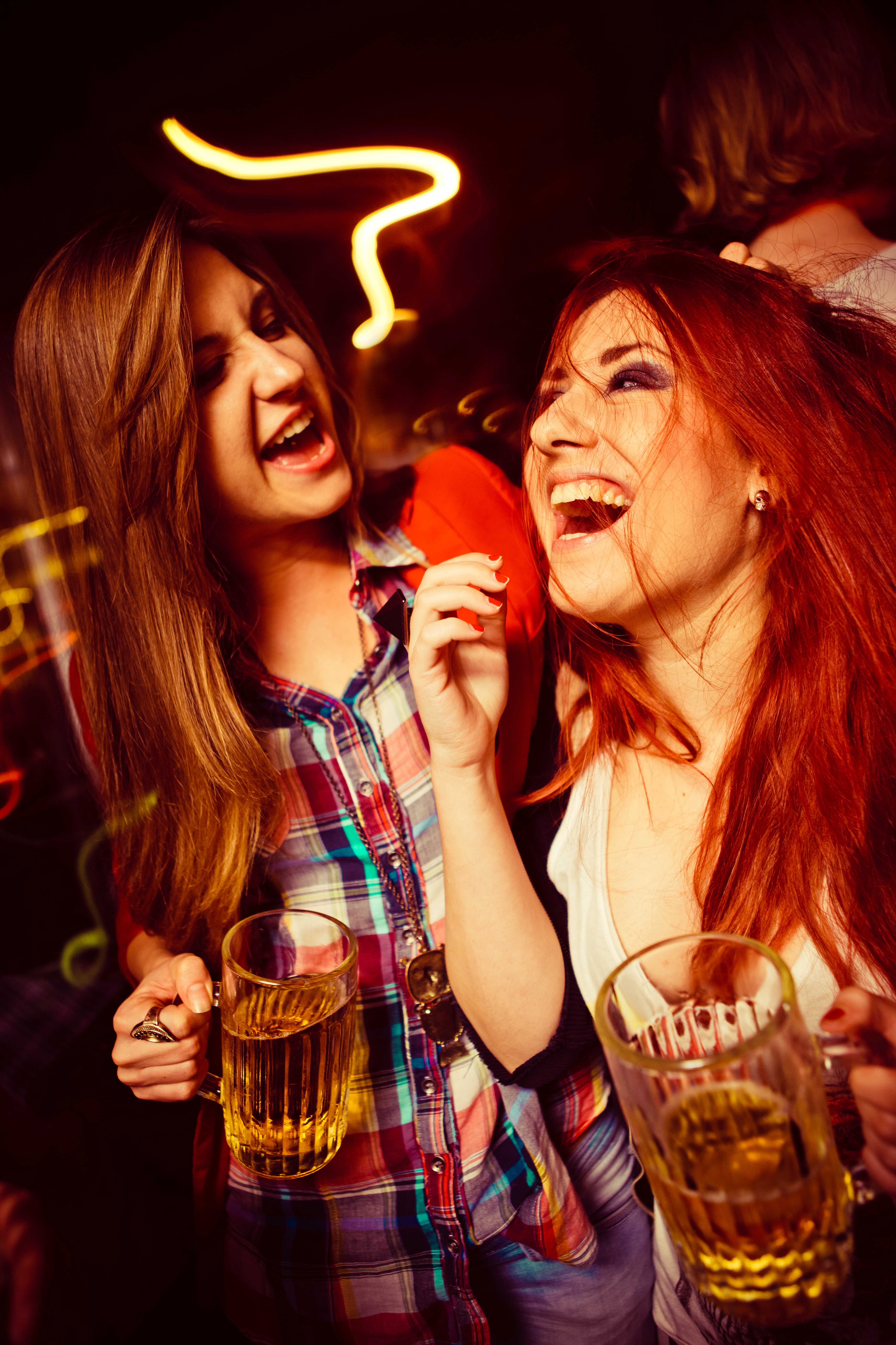 Girls having fun and drinking beer in a nightclub in Venice, Italy
