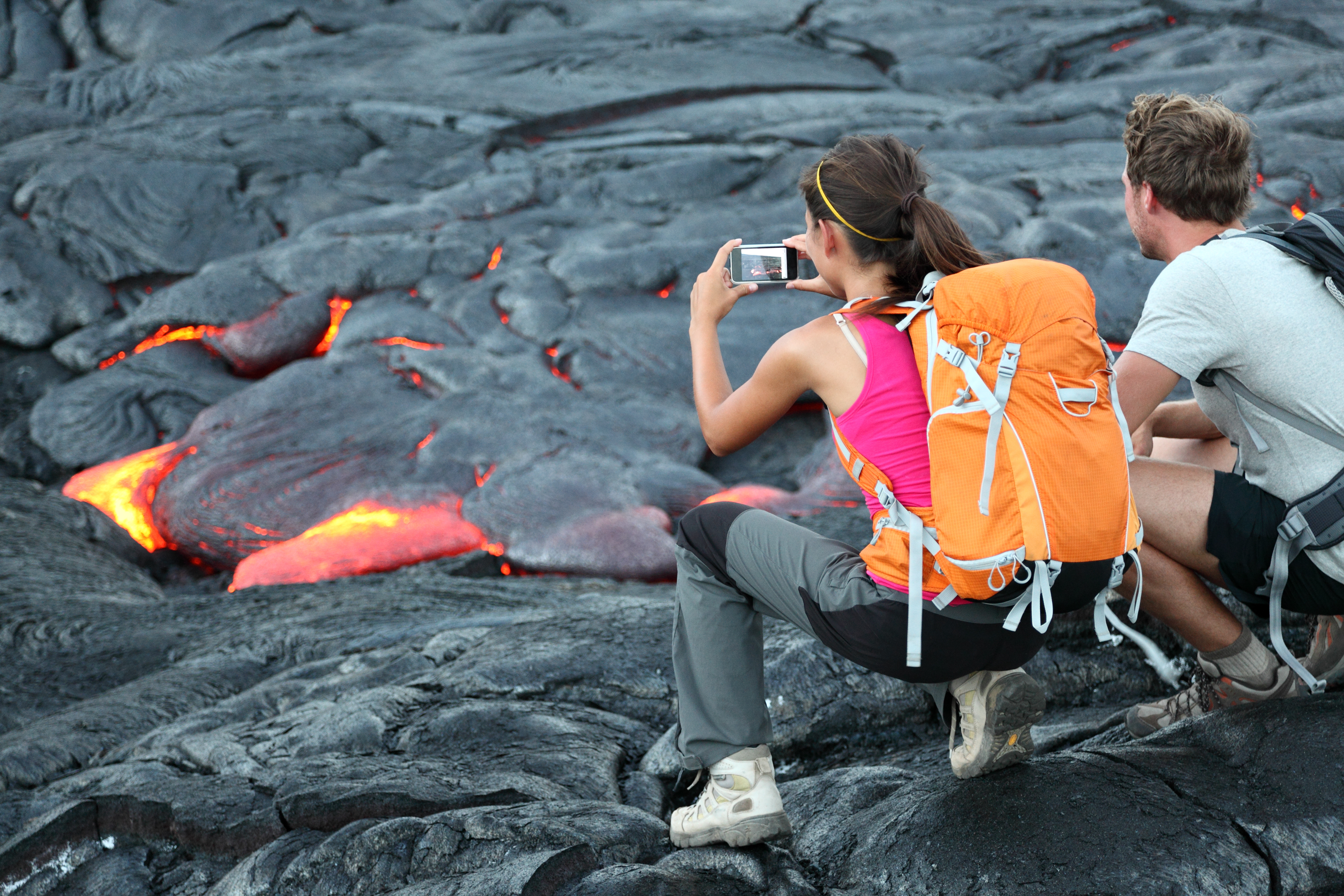 Hawaii lava tourist. Tourists taking photo of flowing lava from Kilauea volcano around Hawaii volcanoes national park, USA