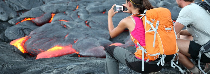 Hawaii lava tourist. Tourists taking photo of flowing lava from Kilauea volcano around Hawaii volcanoes national park, USA