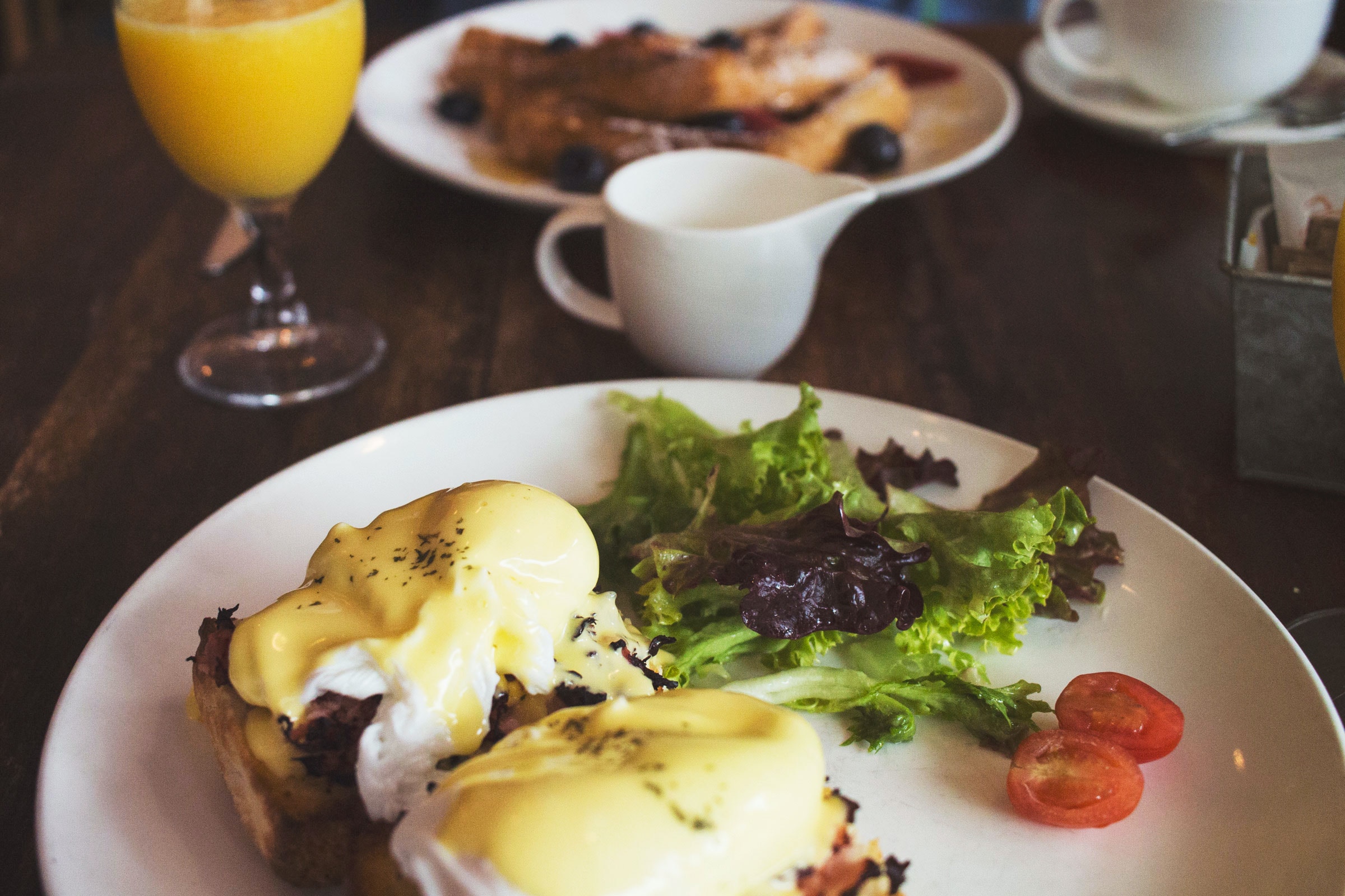 a plate of eggs Benedict and a plate of French toast at a cafe in Liverpool, England