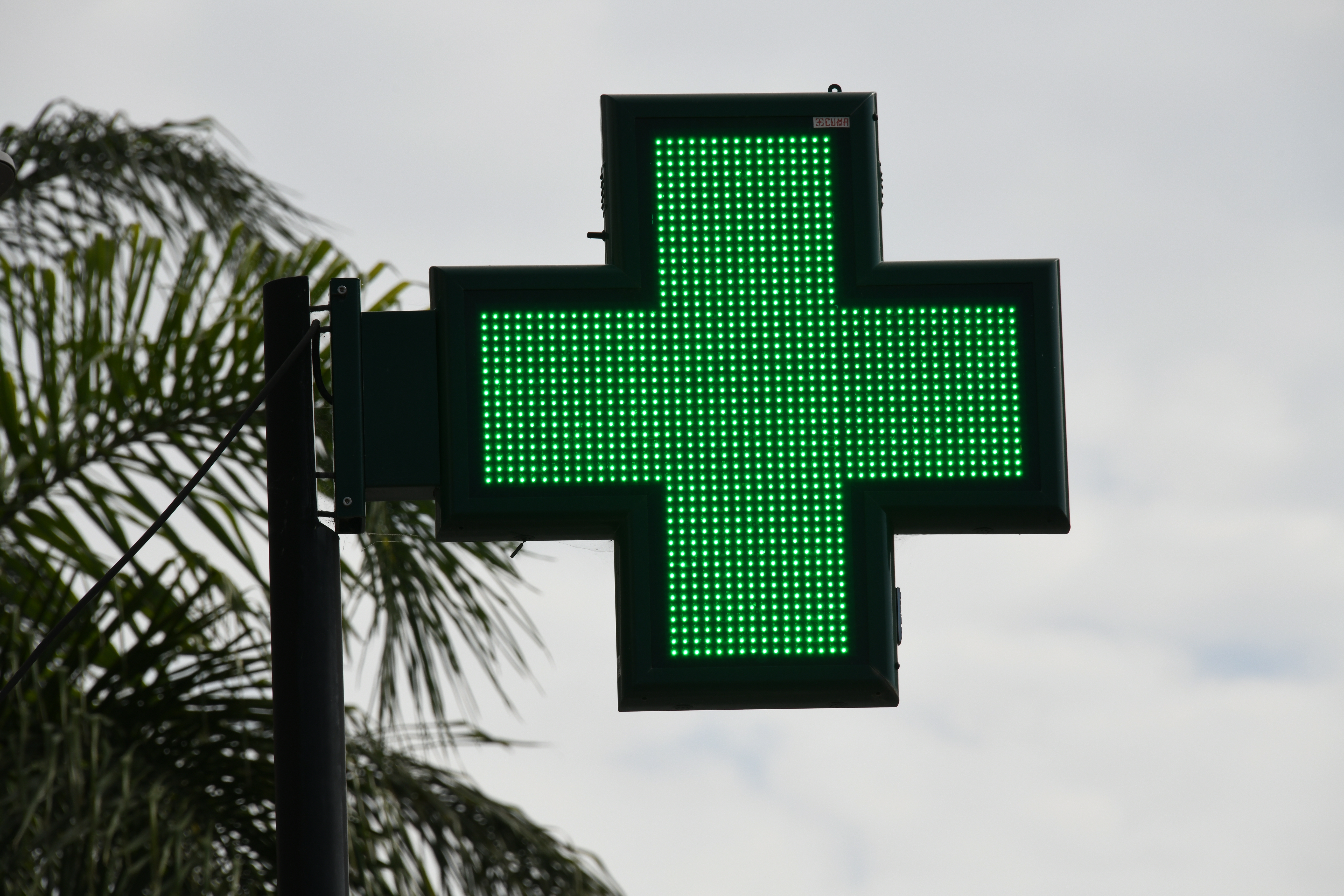 A sign for a pharmacy in the province of Alicante, Spain