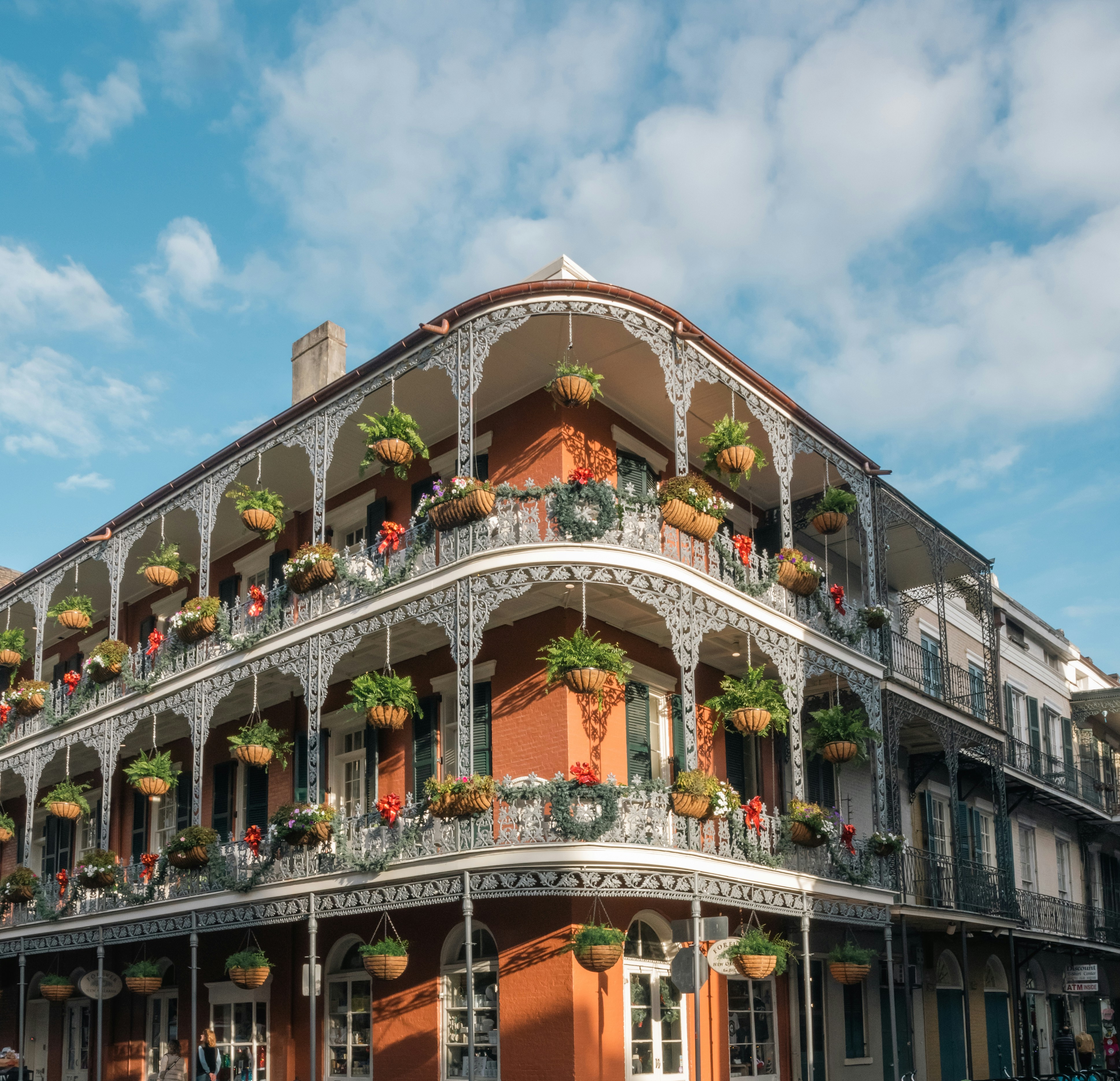 a-tall-building-with-a-balcony-and-flowers-on-the-balconies, new orleans, Louisiana