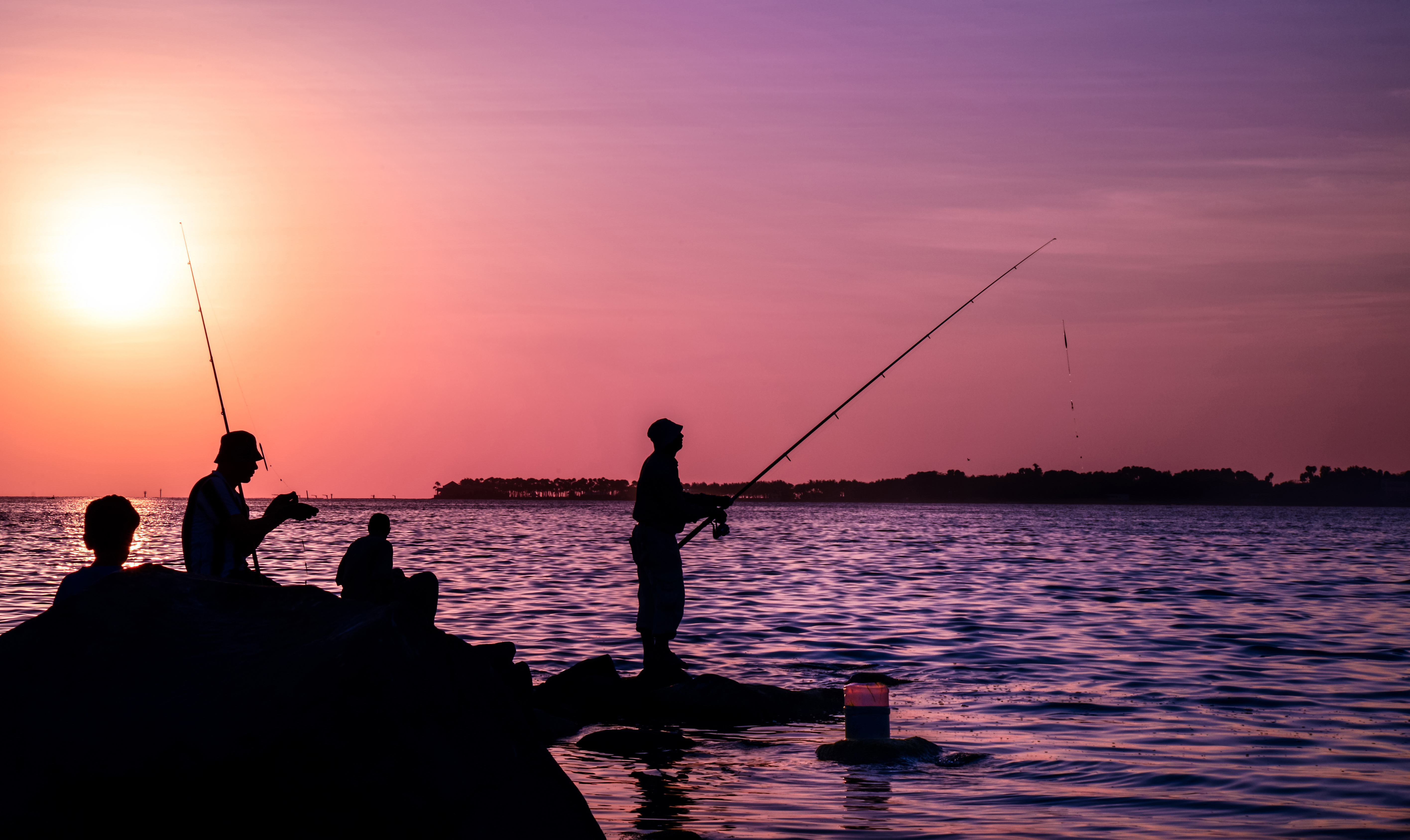 Fishermen fishing in redsea at sunset