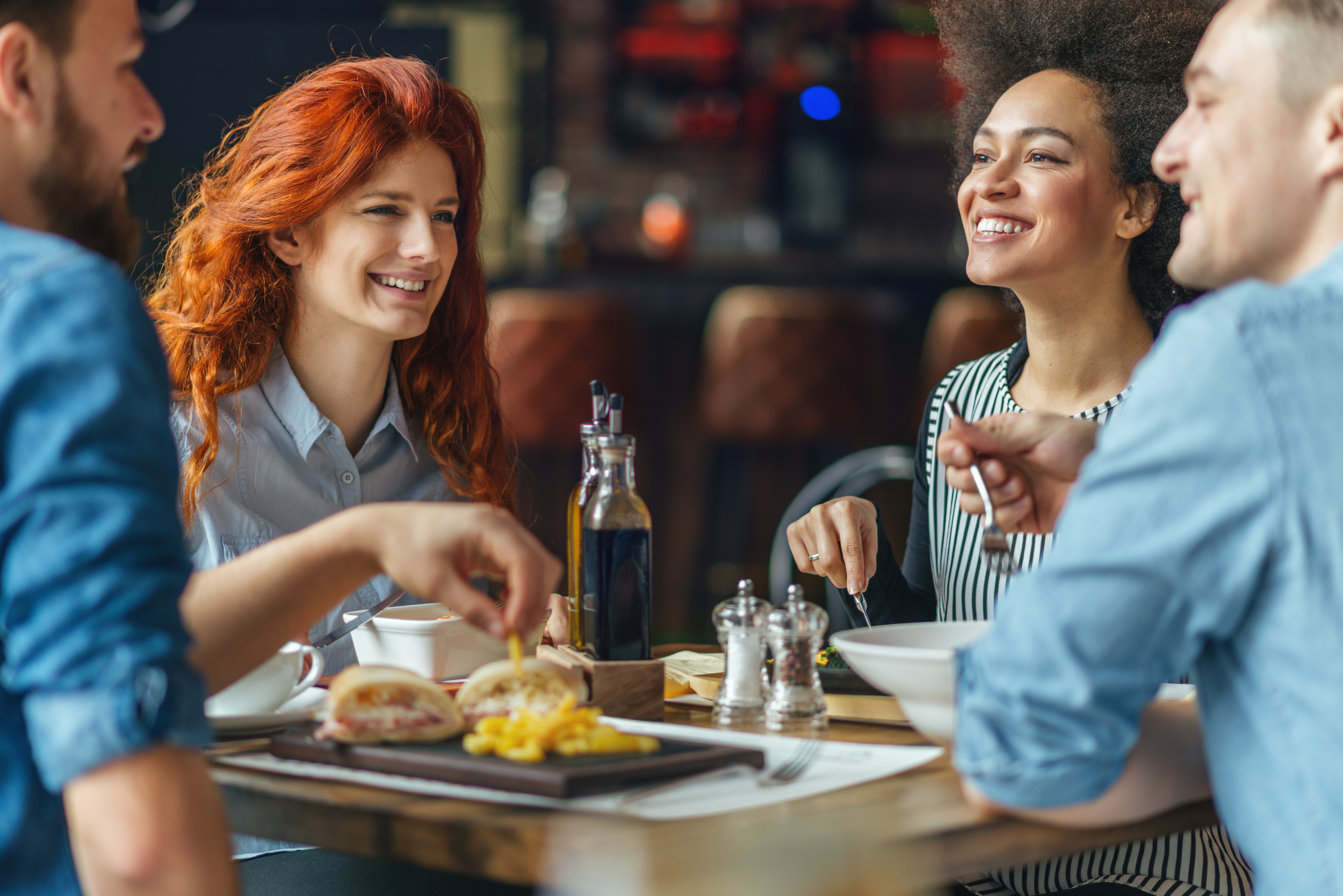 Friends talking and having fun at dinner party